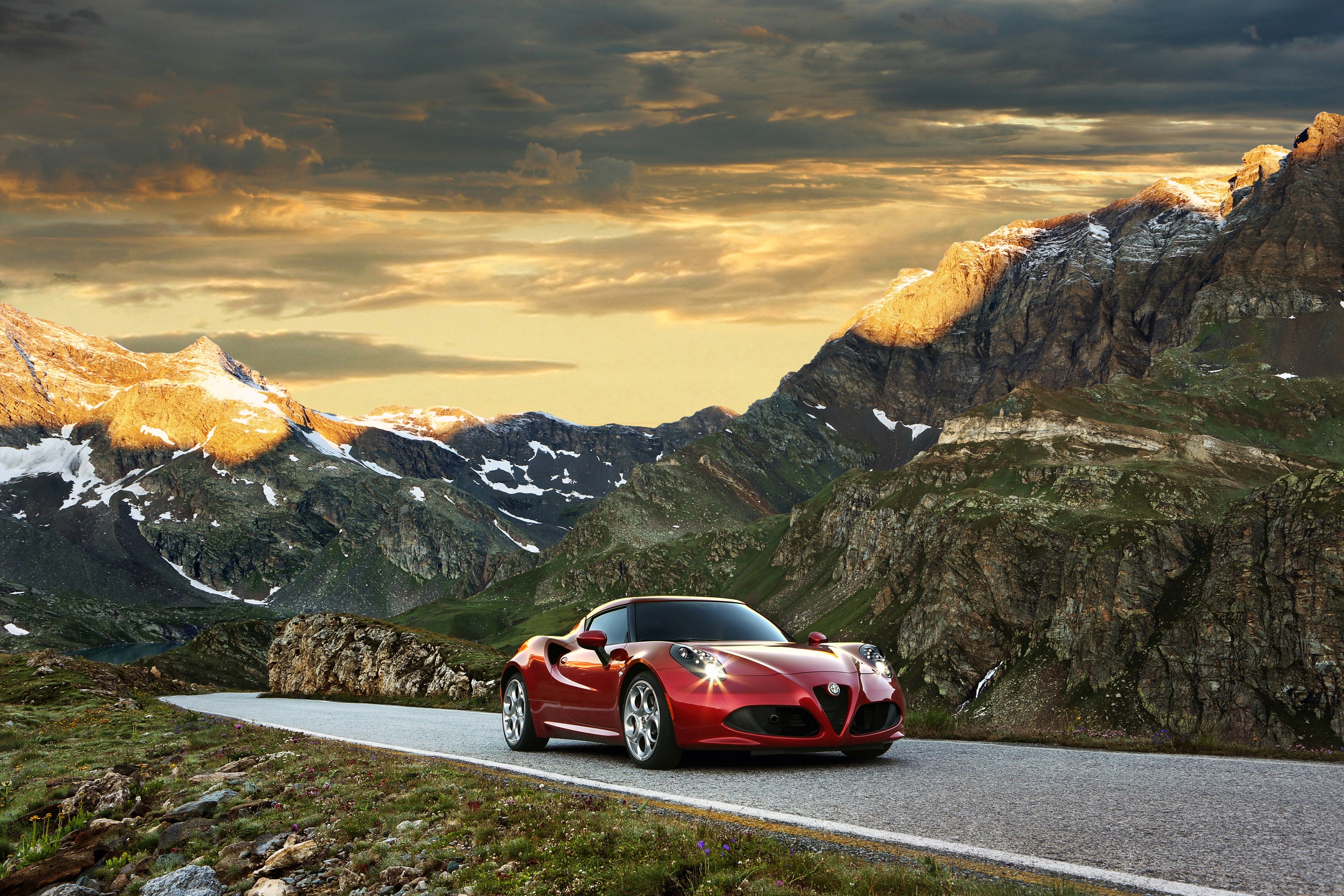 Red Alfa Romeo 4C driving on a mountain road HD Wallpaper