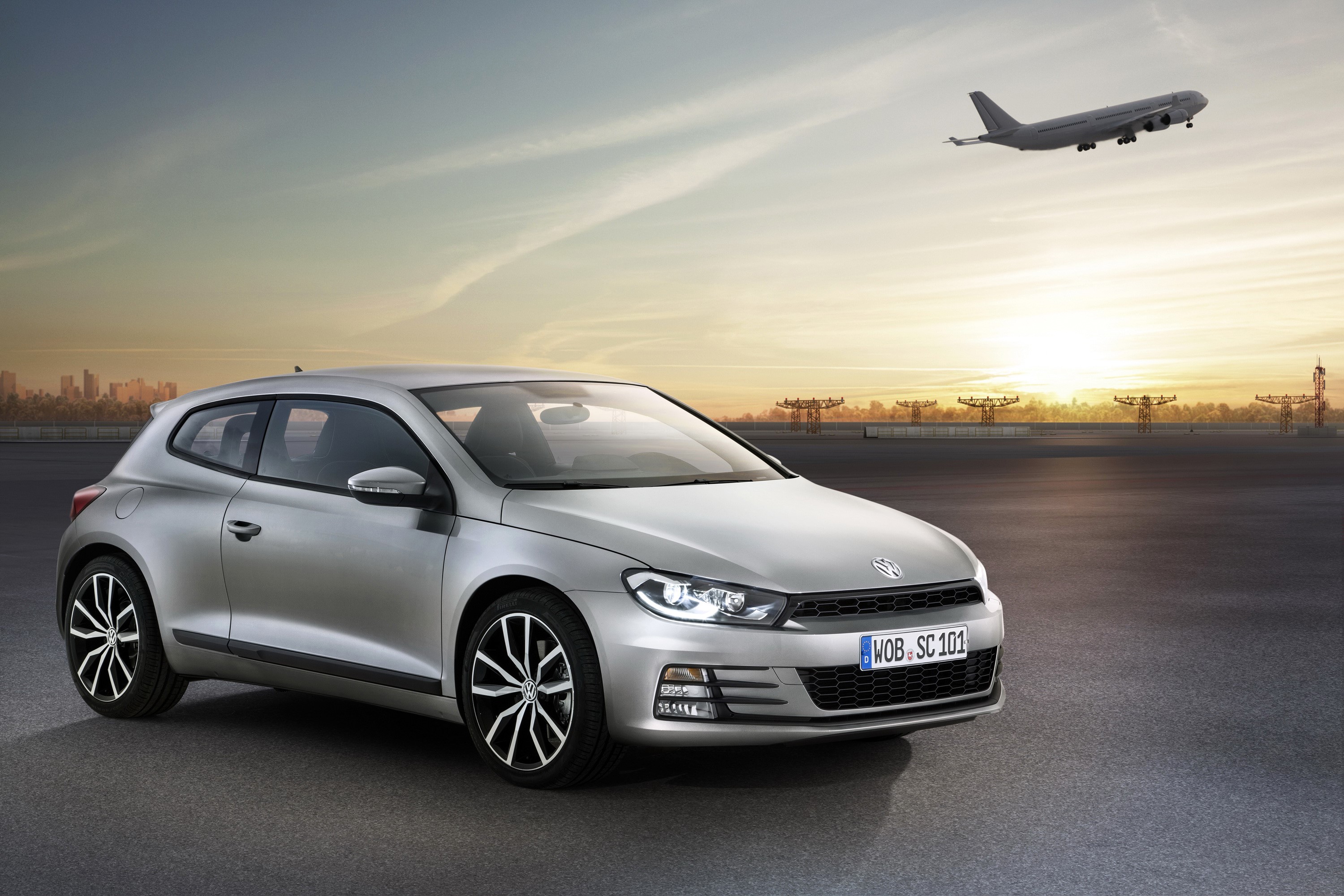 Silver Volkswagen Scirocco 2.0 TSI on airport tarmac HD Wallpaper