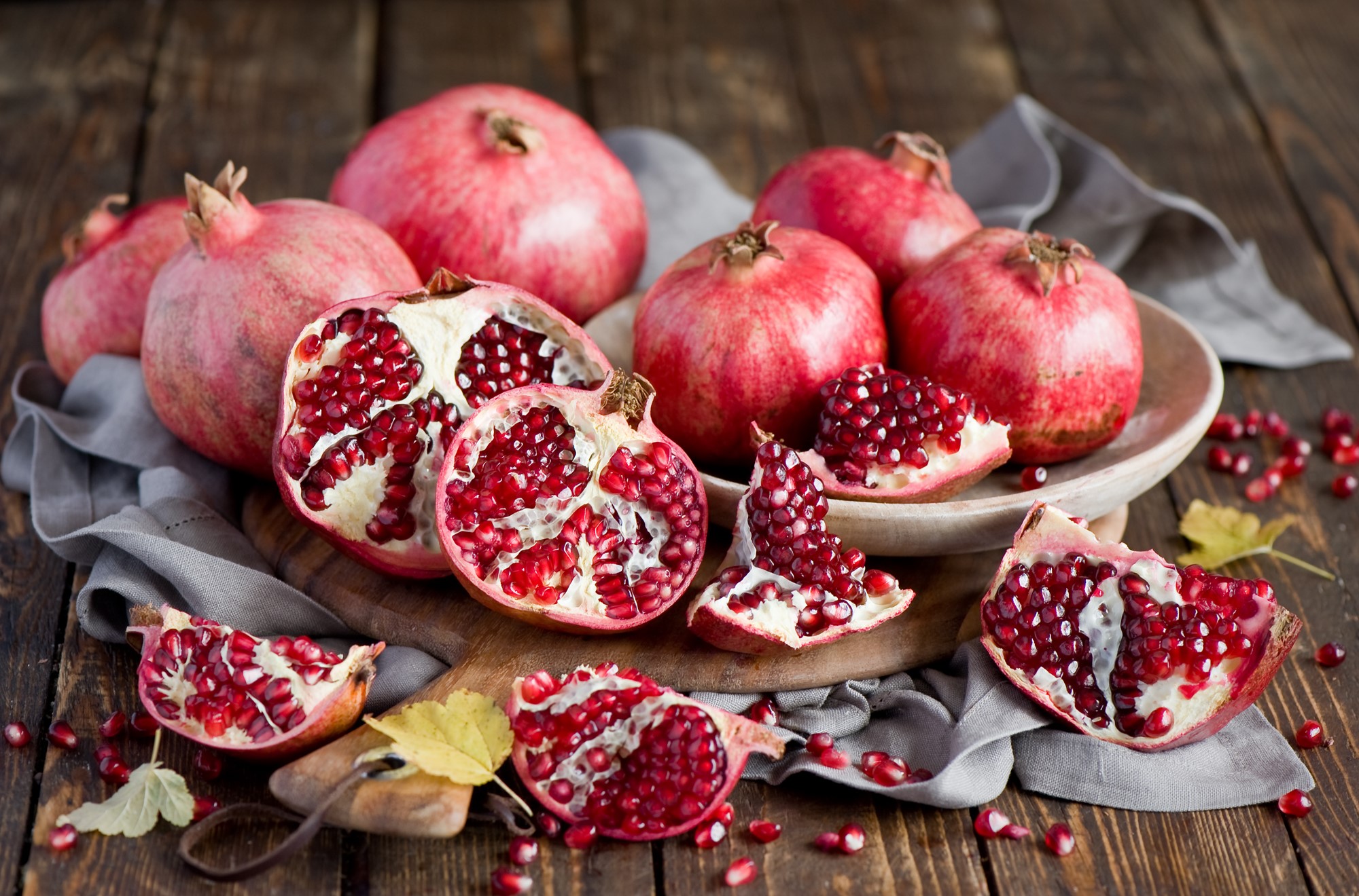 Pomegranates on a wooden table HD Wallpaper