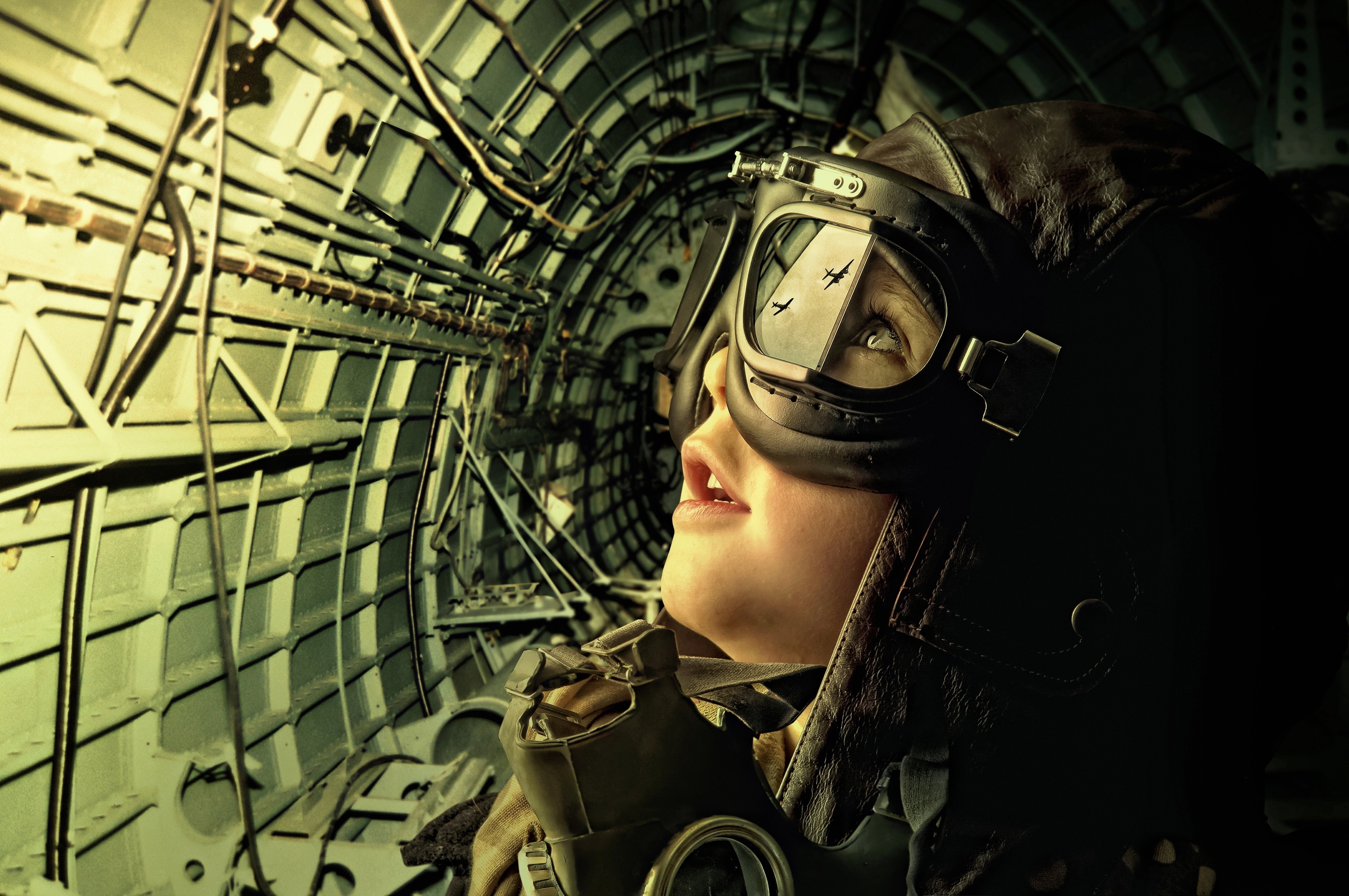 Girl in pilot helmet and goggles inside aircraft HD Wallpaper