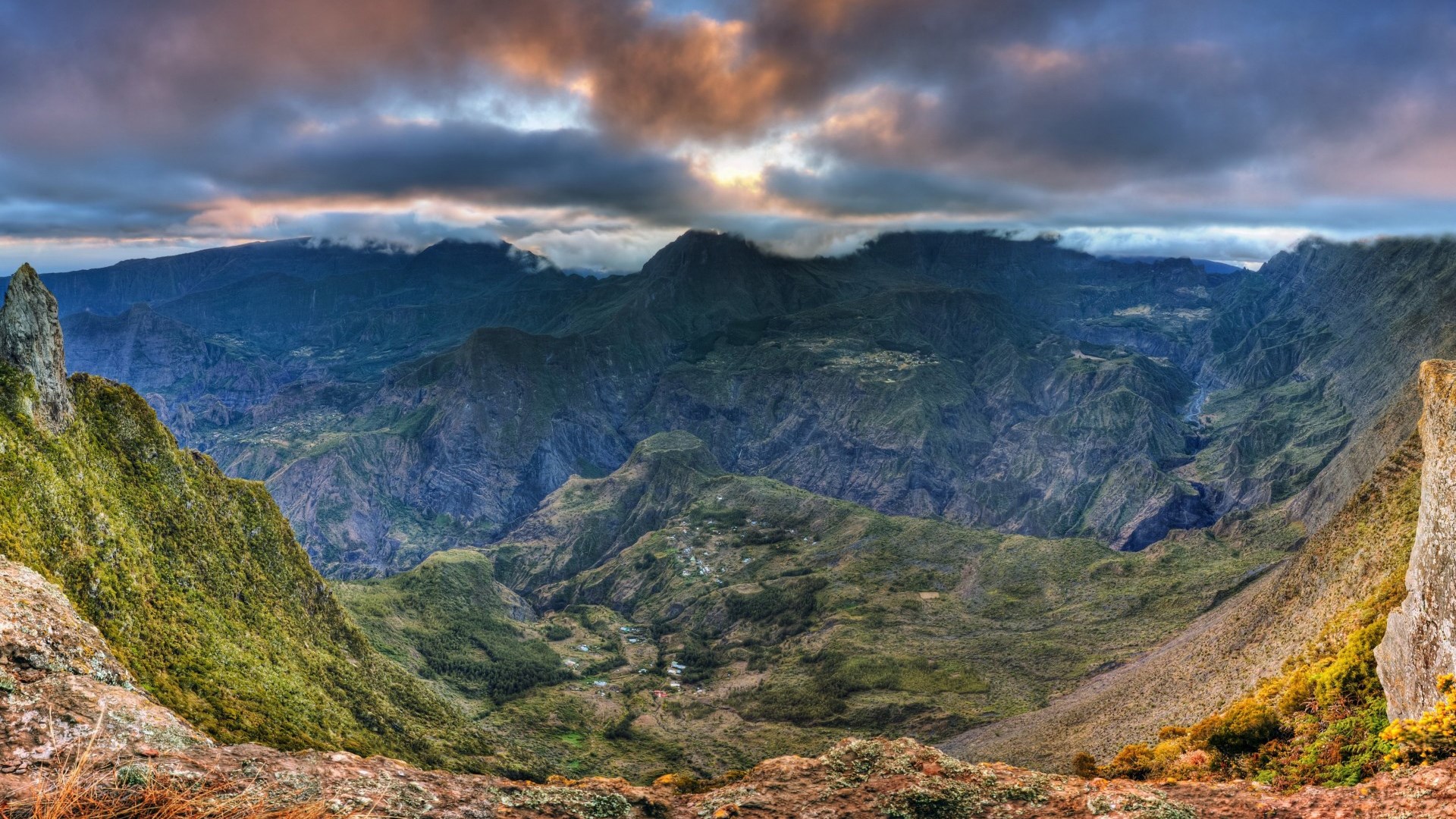 Panoramic view of a mountainous valley with clouds HD Wallpaper