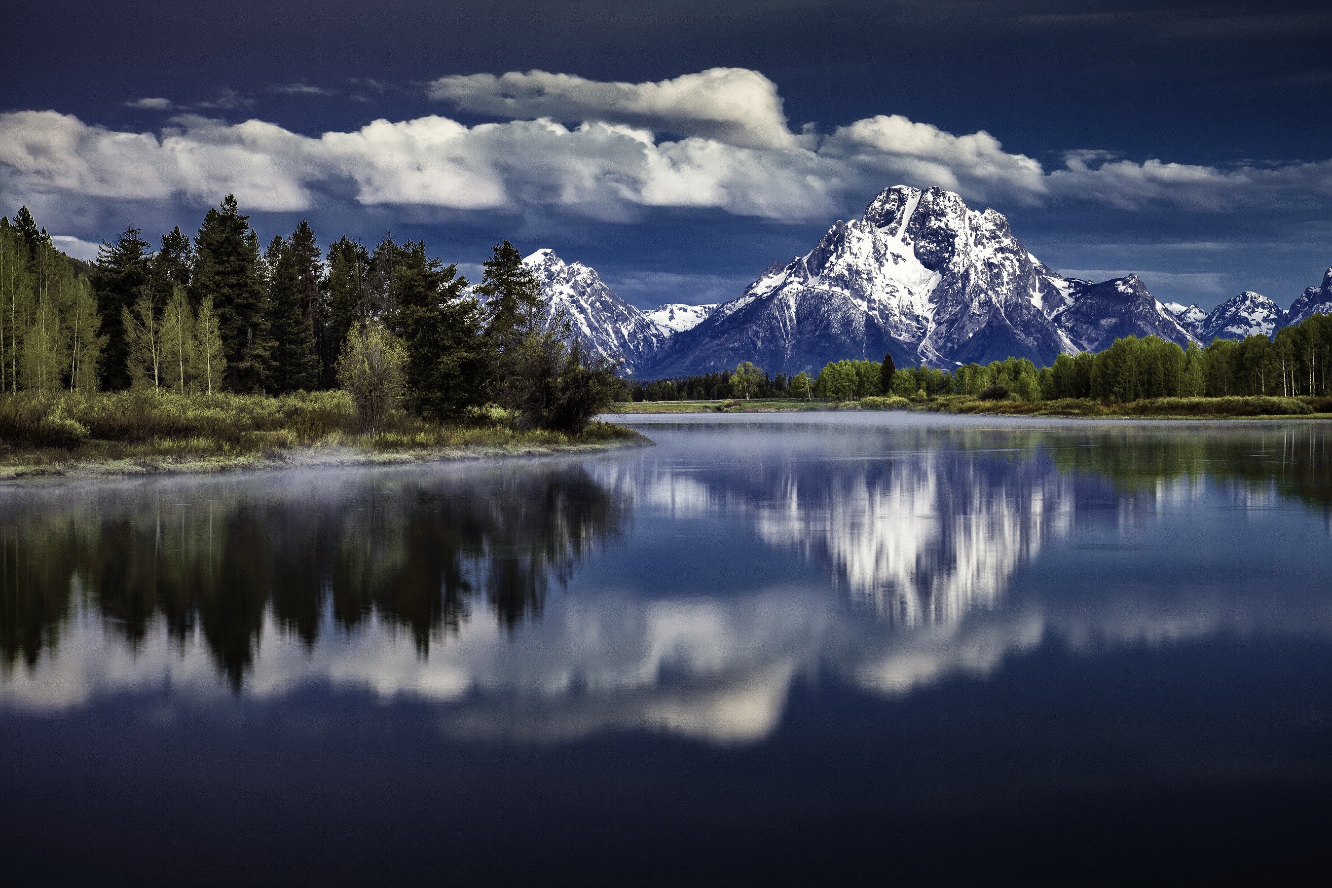 Grand Teton Mountains reflected in a lake with forest HD Wallpaper