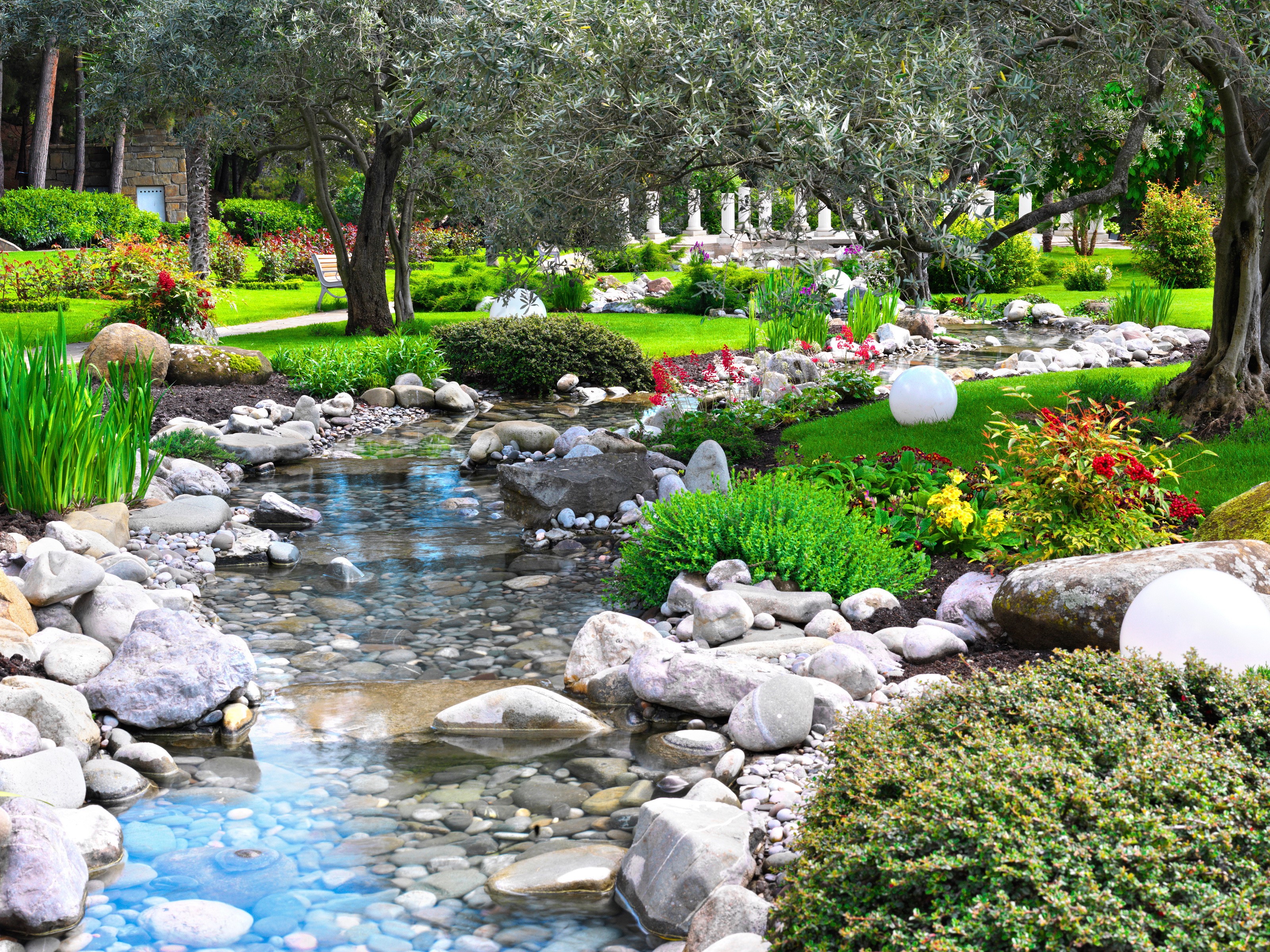 A beautiful garden with a stream and stones HD Wallpaper