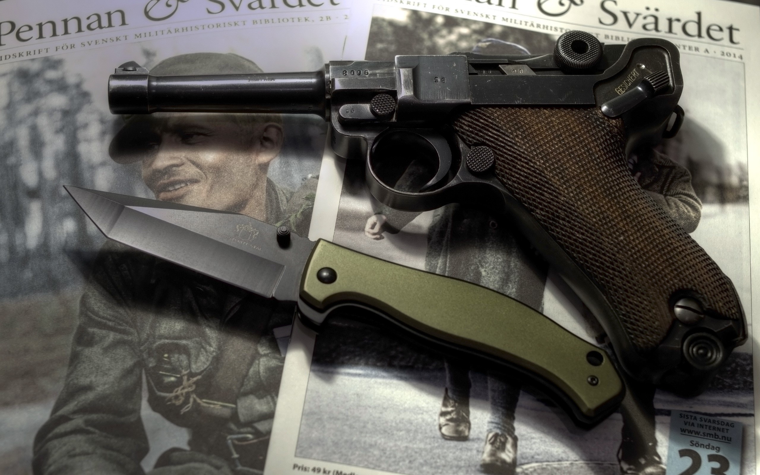 Luger pistol and knife on military magazine HD Wallpaper
