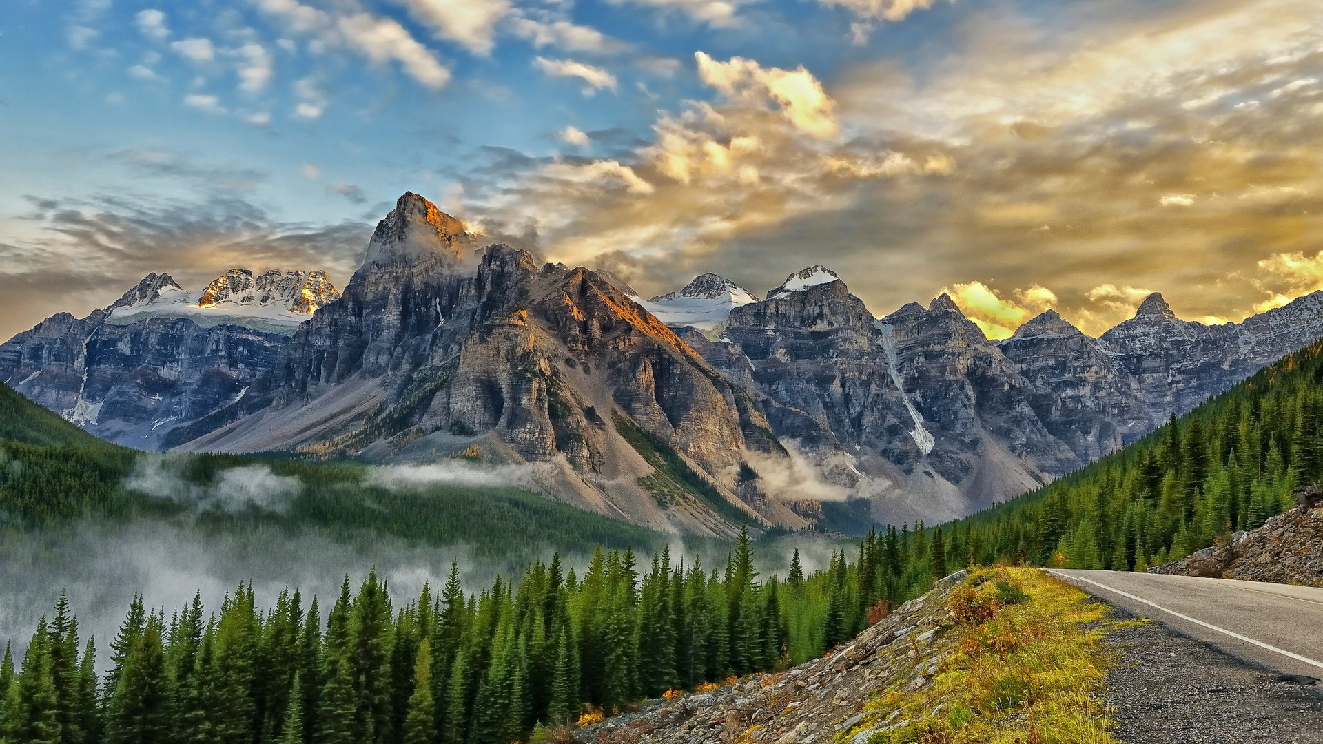 Mountain range with pine forest and road HD Wallpaper