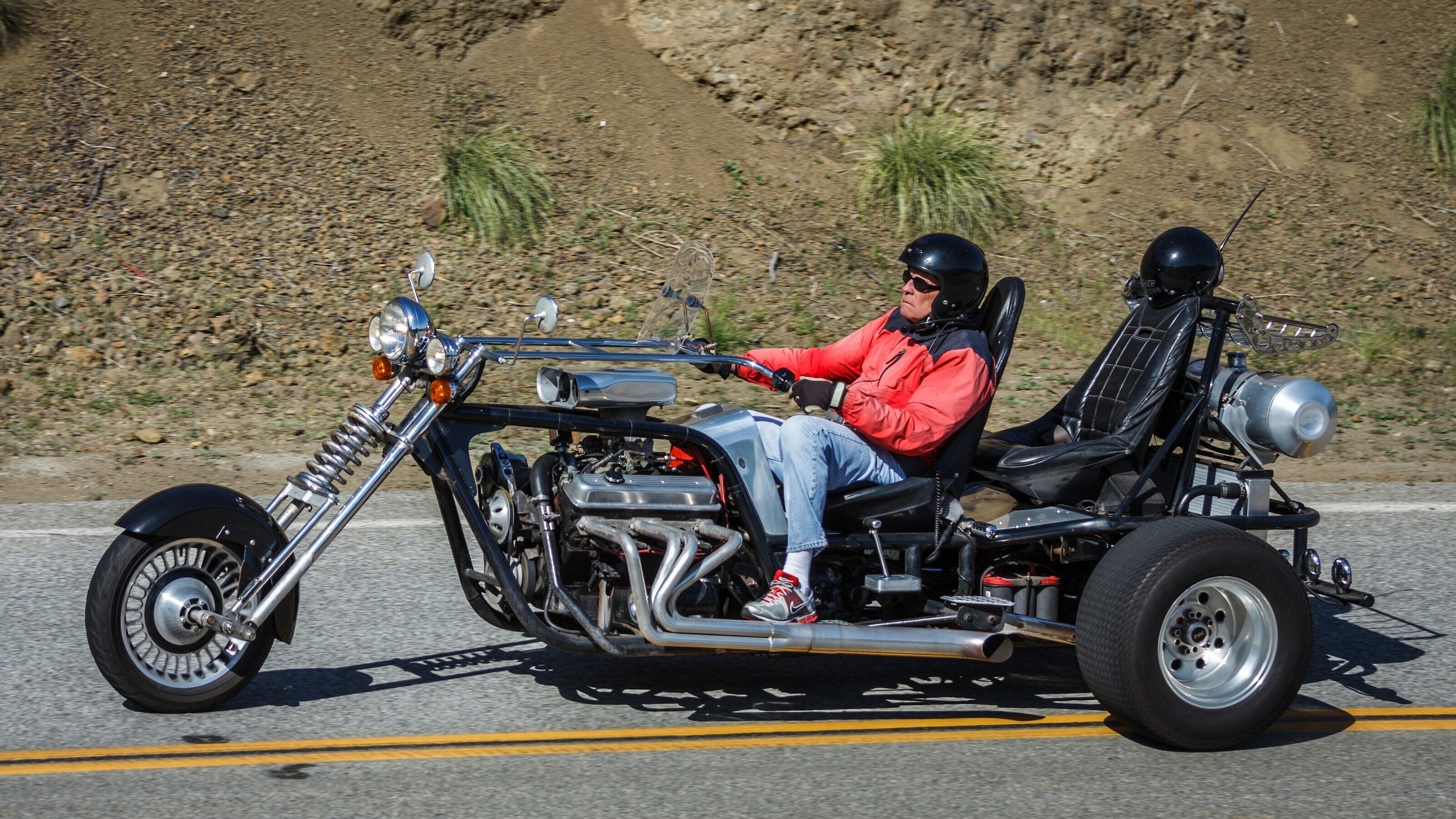 Man riding a V8 trike on a road HD Wallpaper