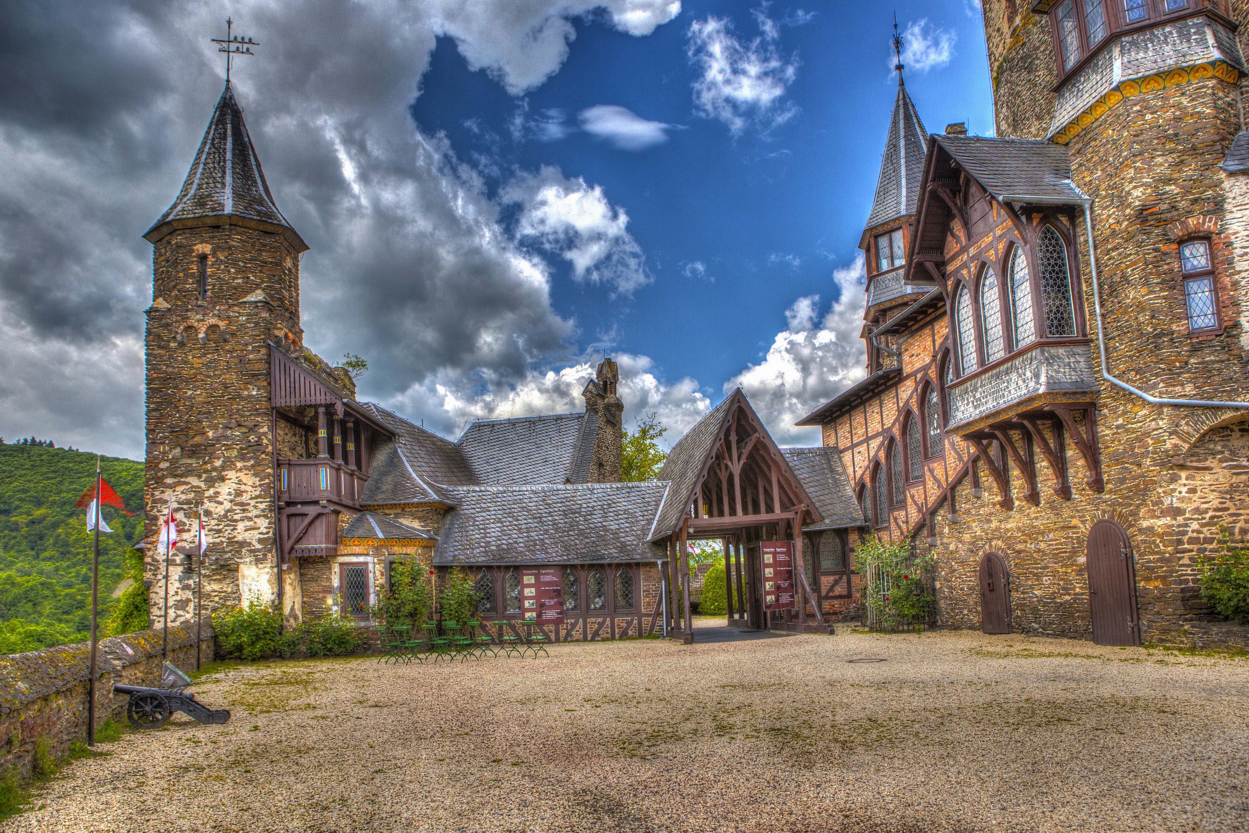 Castle courtyard with towers and flags HD Wallpaper