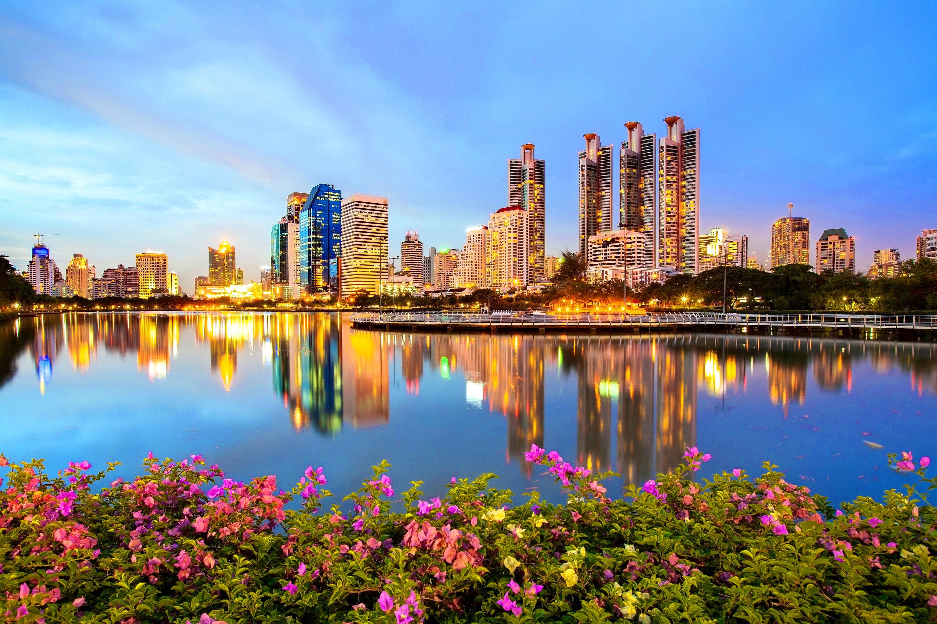 Cityscape with lake and flowers at dusk HD Wallpaper