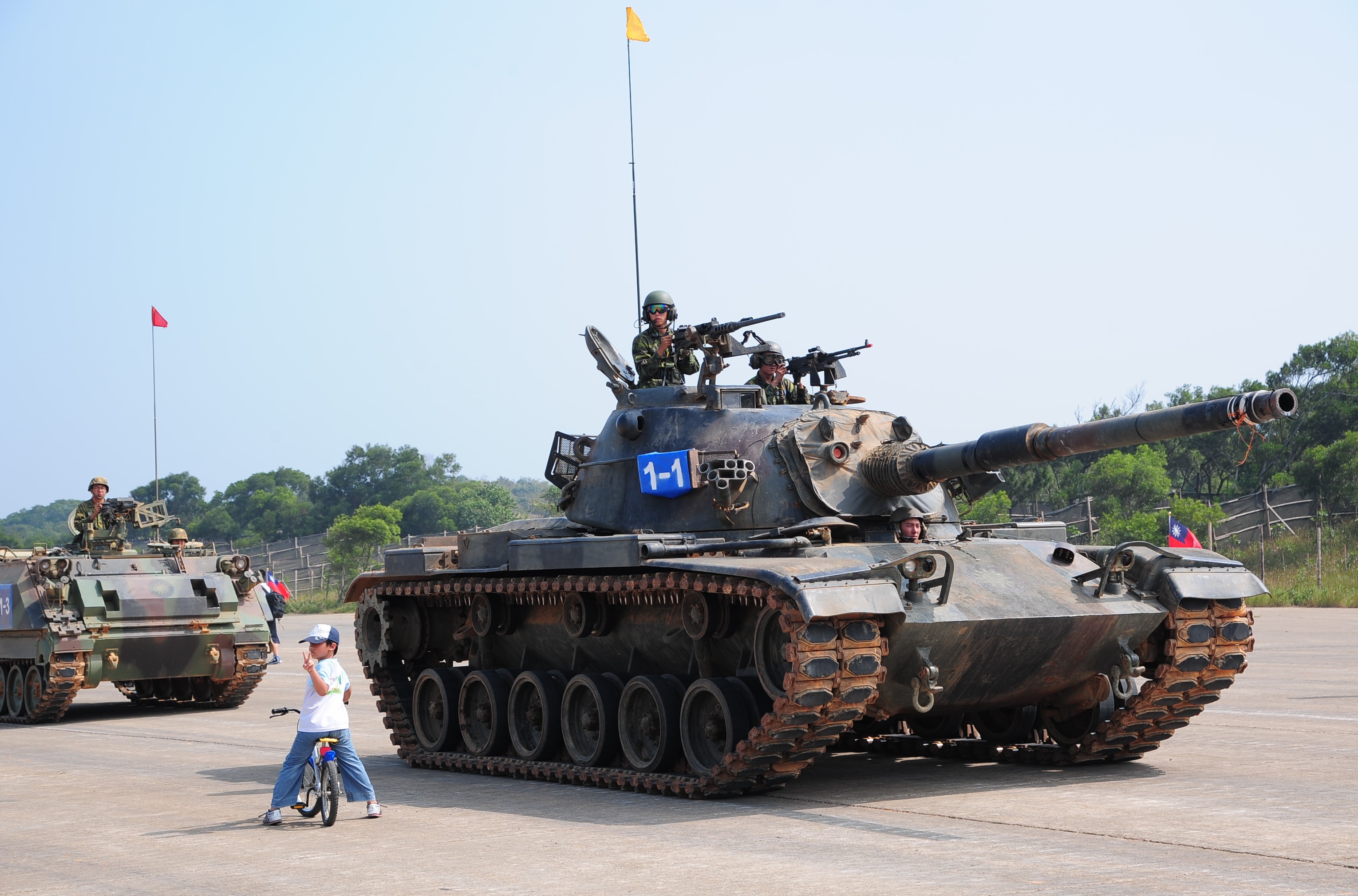 CM-11 tanks with soldiers and a child on a bicycle HD Wallpaper