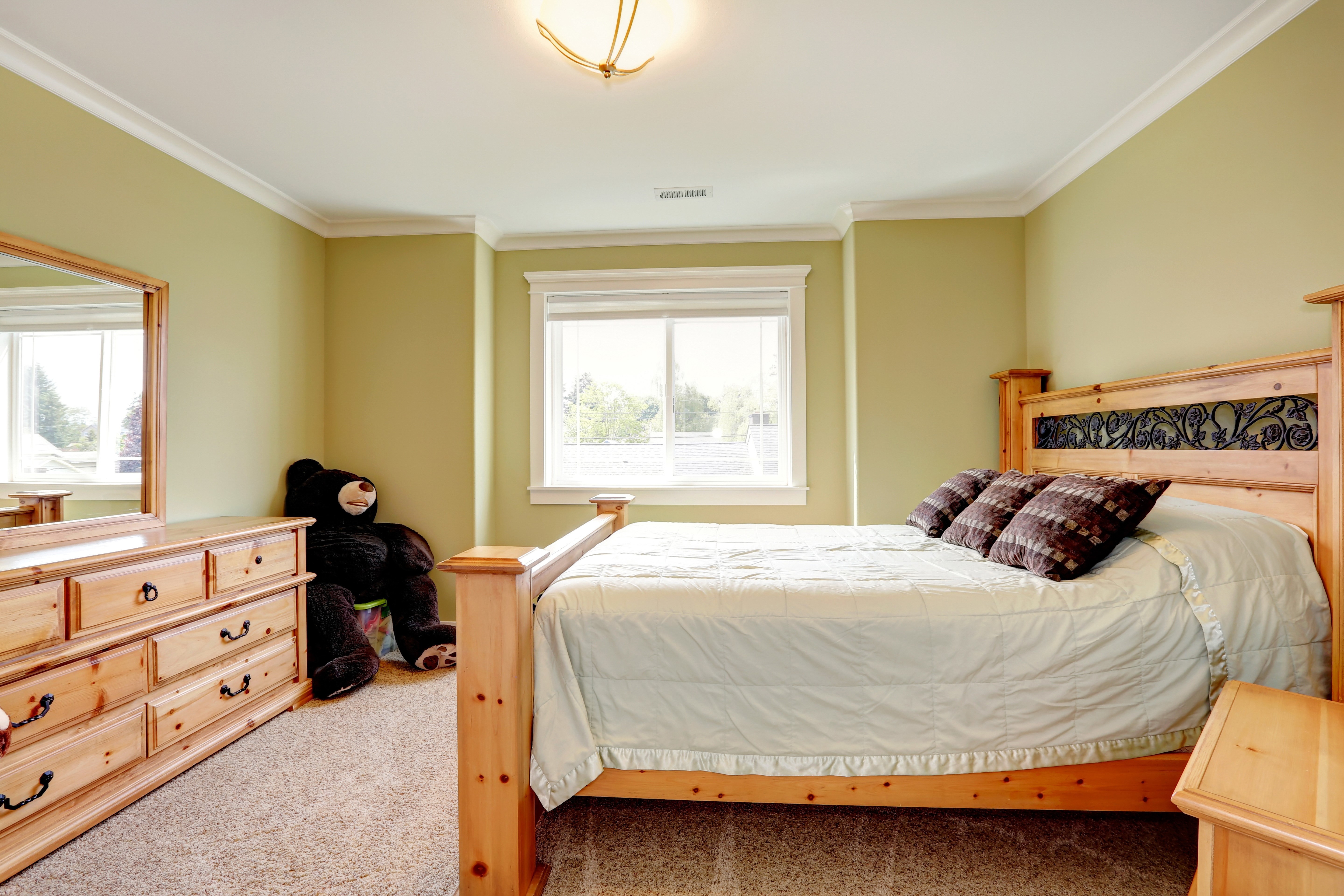 Bedroom with wooden furniture and a large teddy bear HD Wallpaper