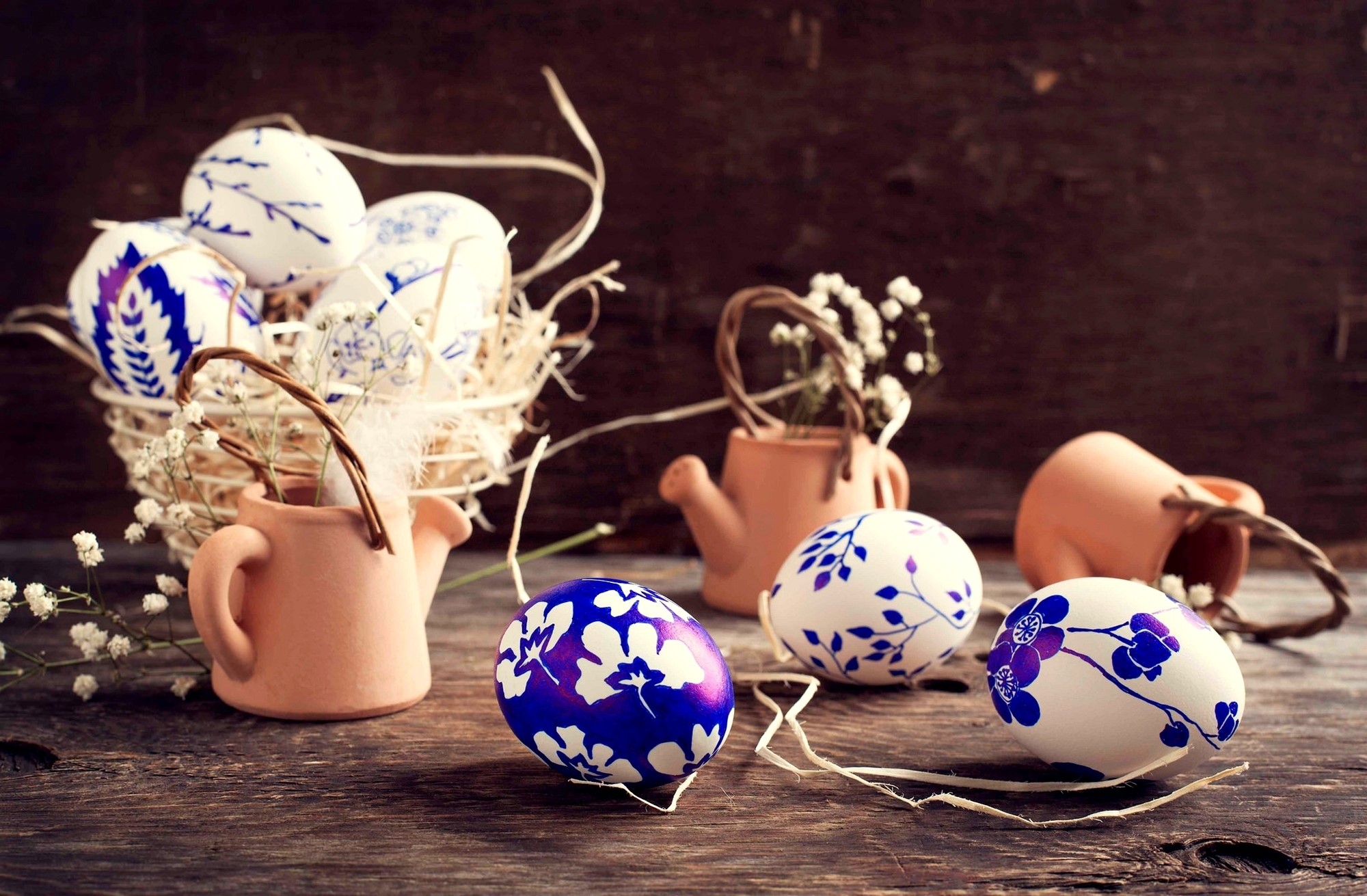 Easter eggs decorated with blue floral patterns in a rustic setting HD Wallpaper