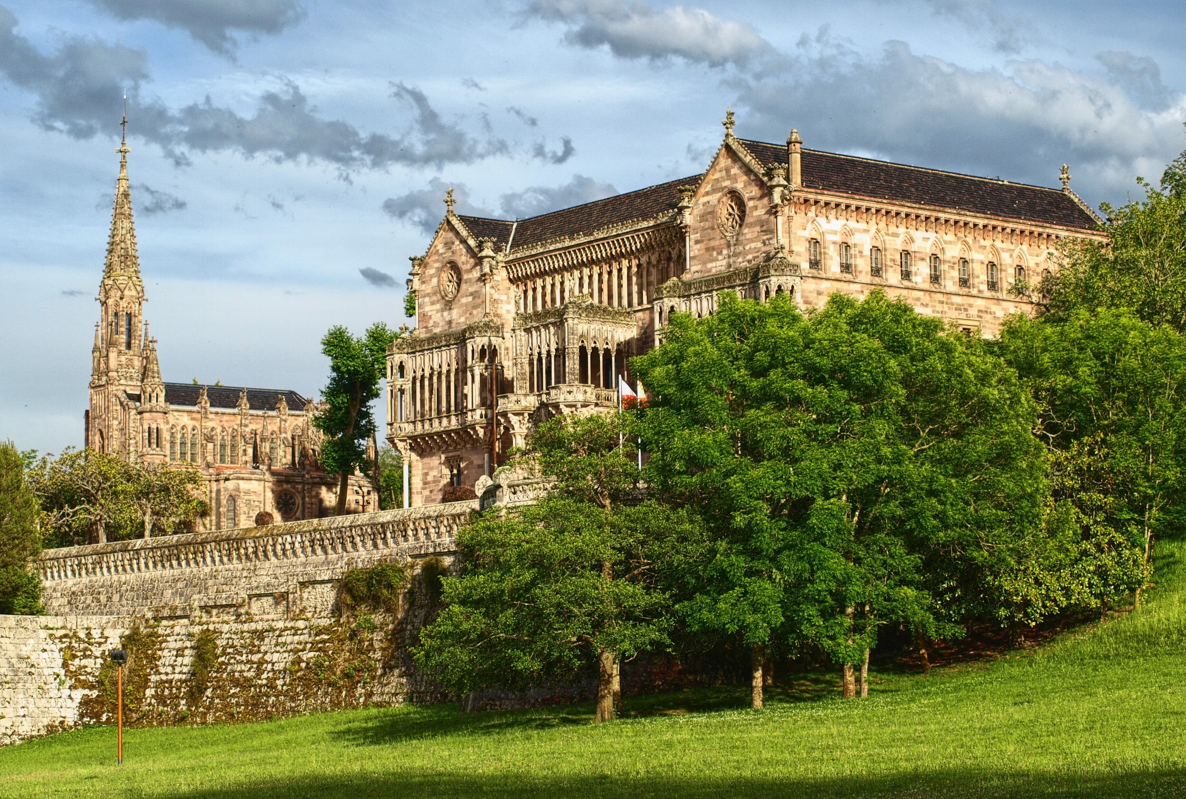 Palacio de Sobrellano in Cantabria, Spain with trees and lawn HD Wallpaper