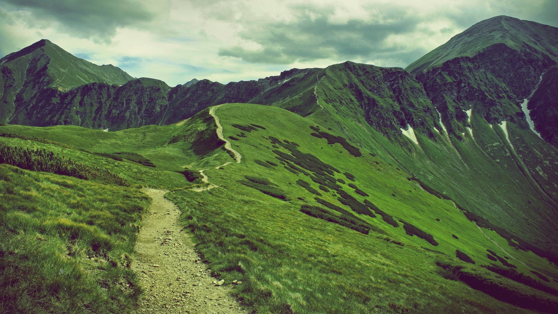 Mountain range with a winding path HD Wallpaper
