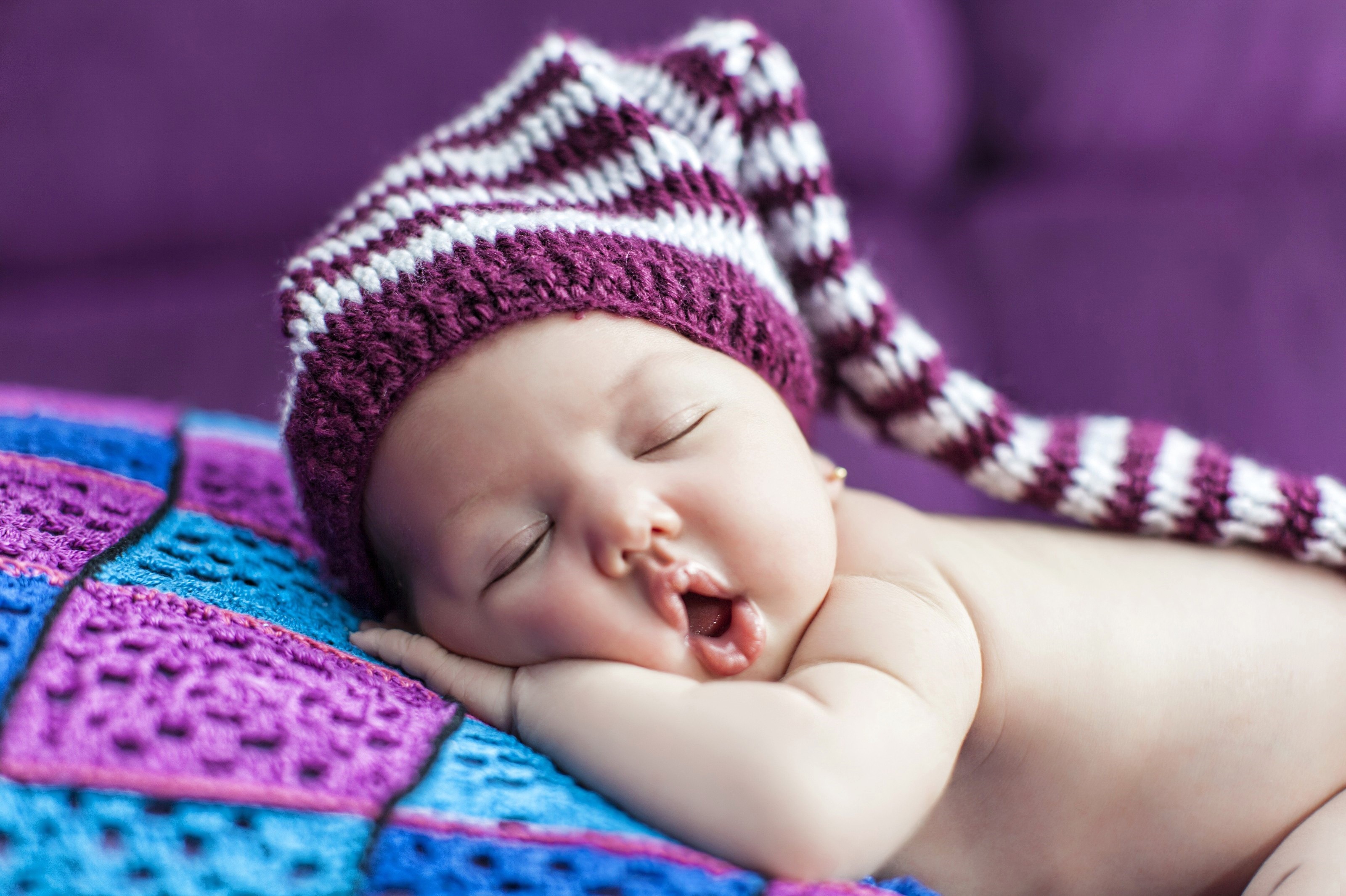 Baby sleeping in a striped hat HD Wallpaper