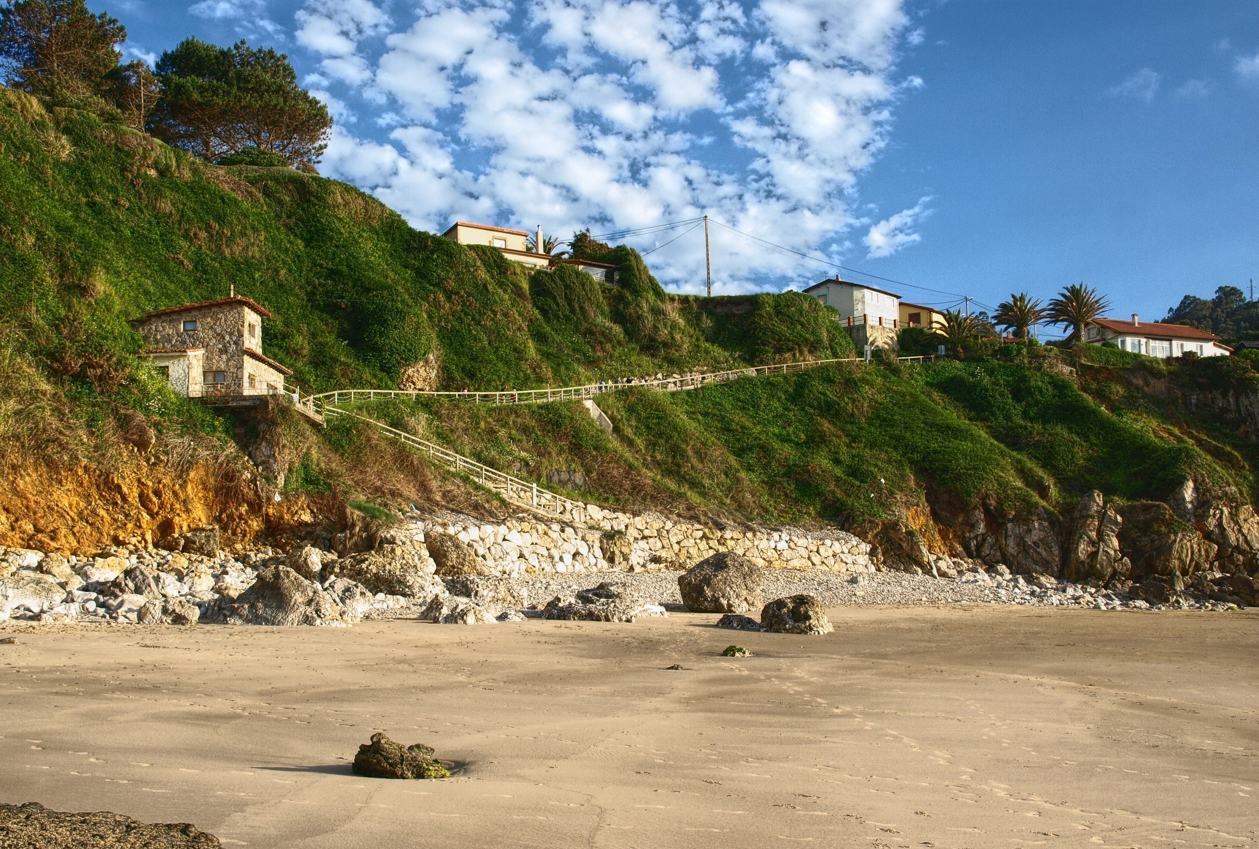 Coastal cliff with houses and beach in Cantabria, Spain HD Wallpaper