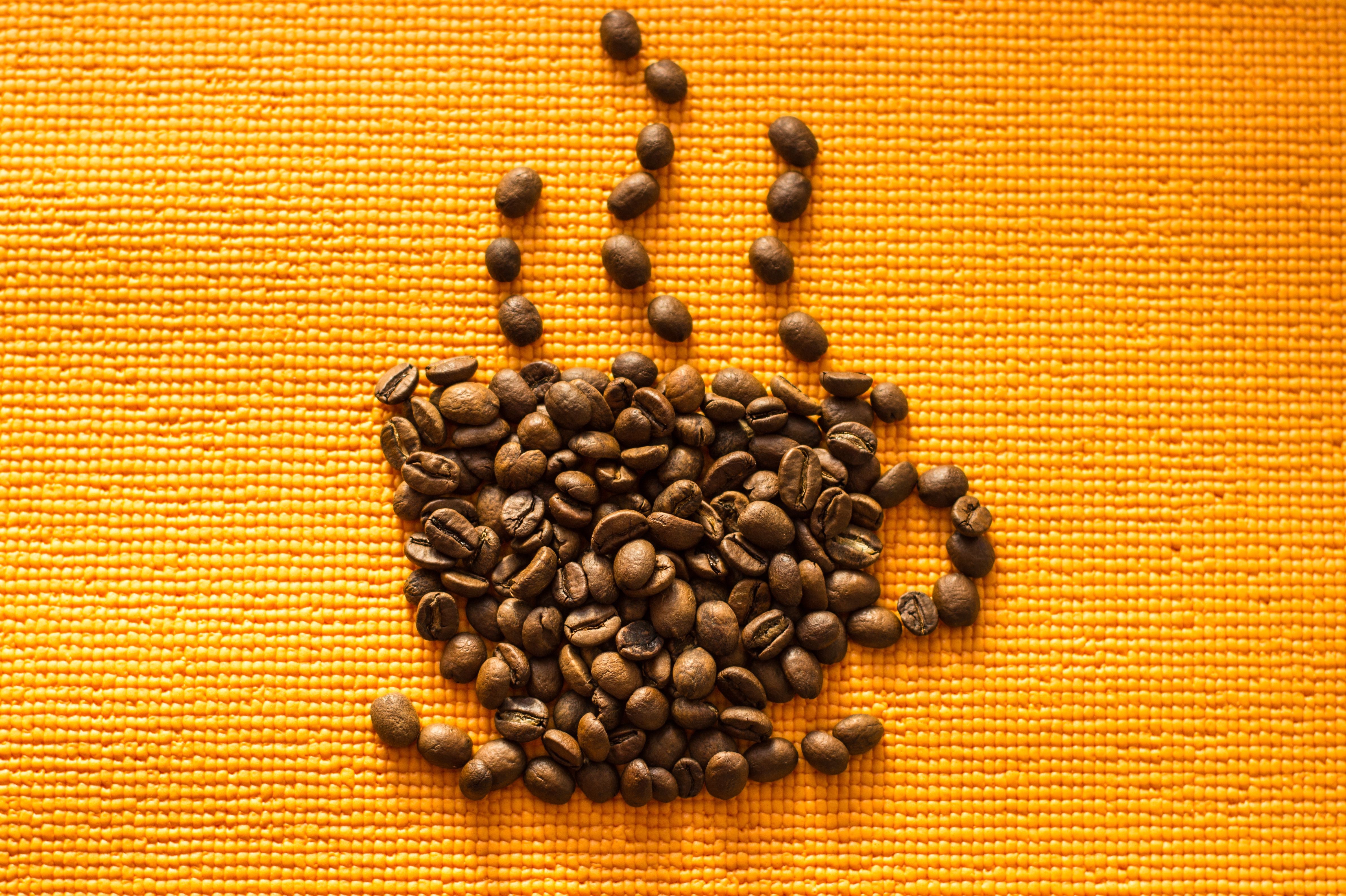 Coffee beans forming a cup with steam HD Wallpaper