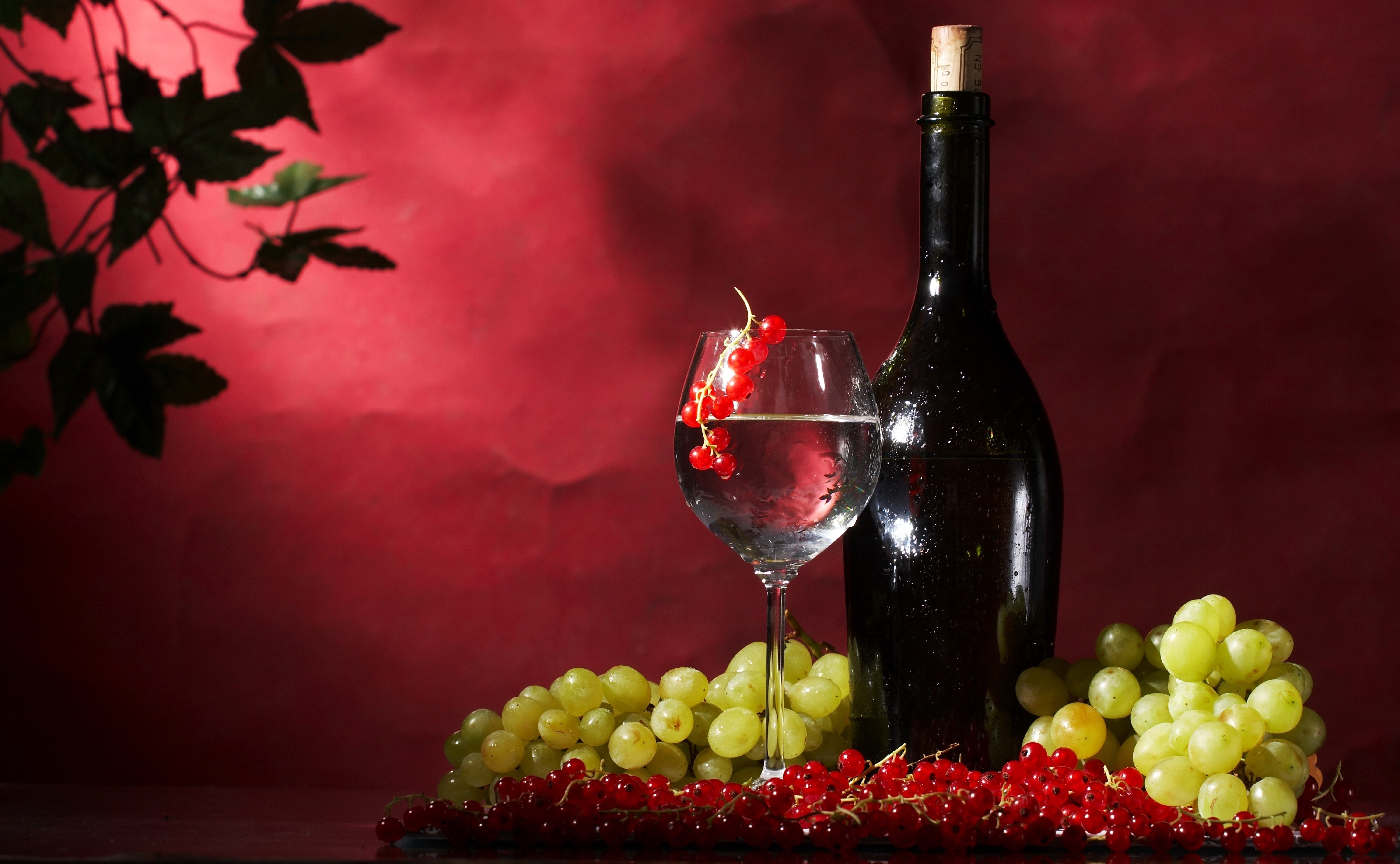 Wine bottle, glass, grapes, and currants on a red background HD Wallpaper