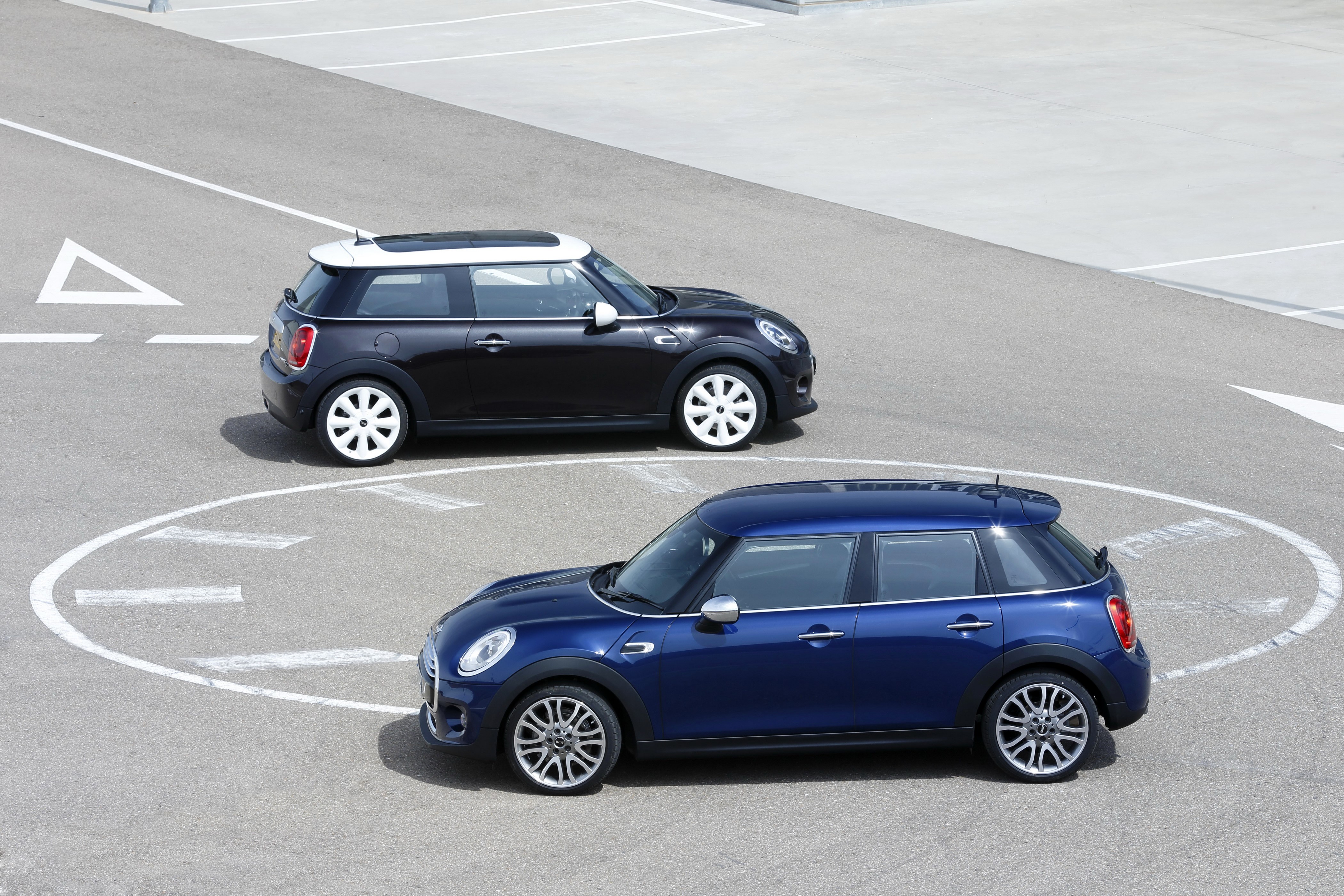 Two Mini Cooper cars on a road HD Wallpaper