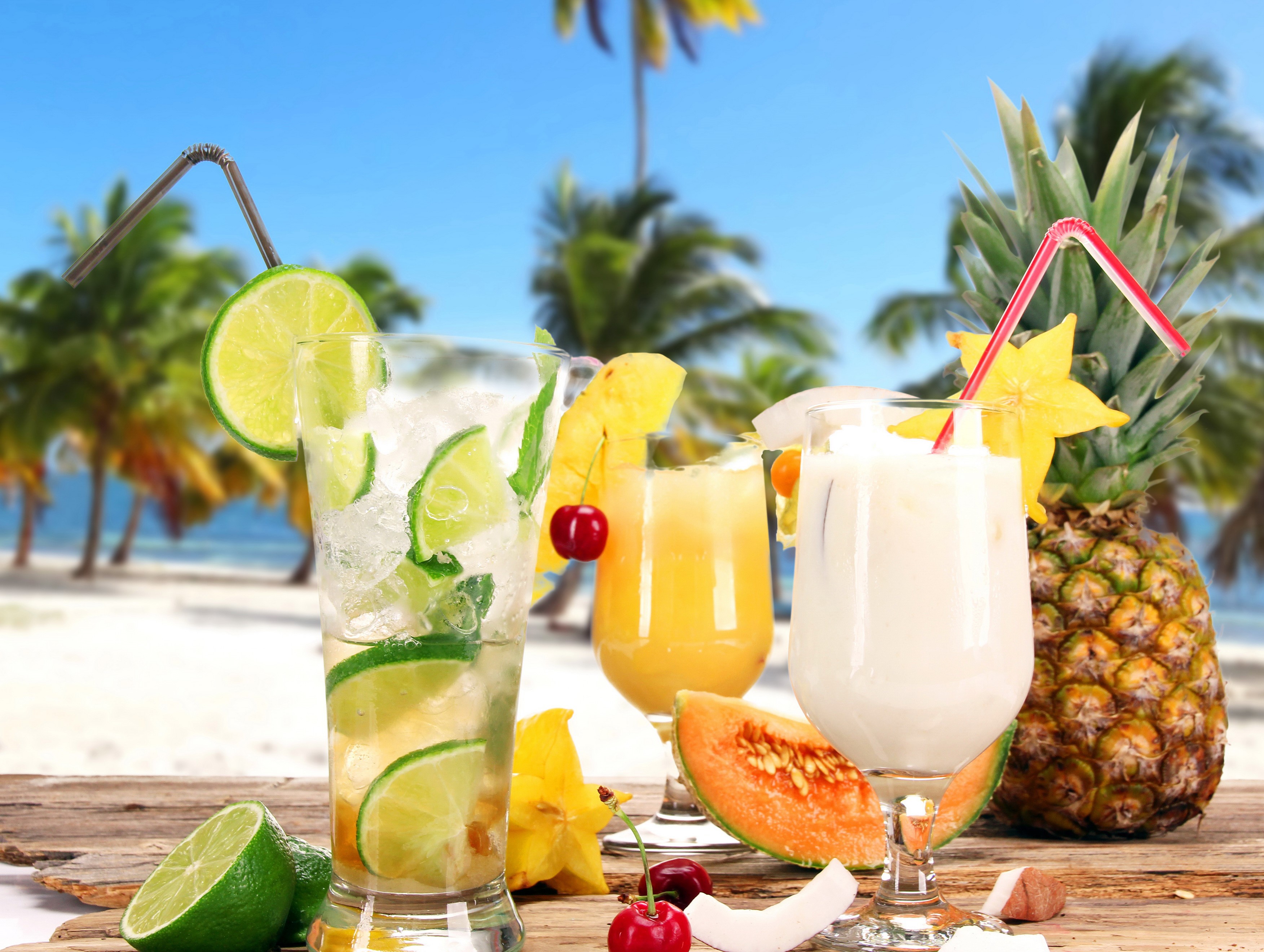 Tropical Drinks with Fruits on a Beach Background HD Wallpaper