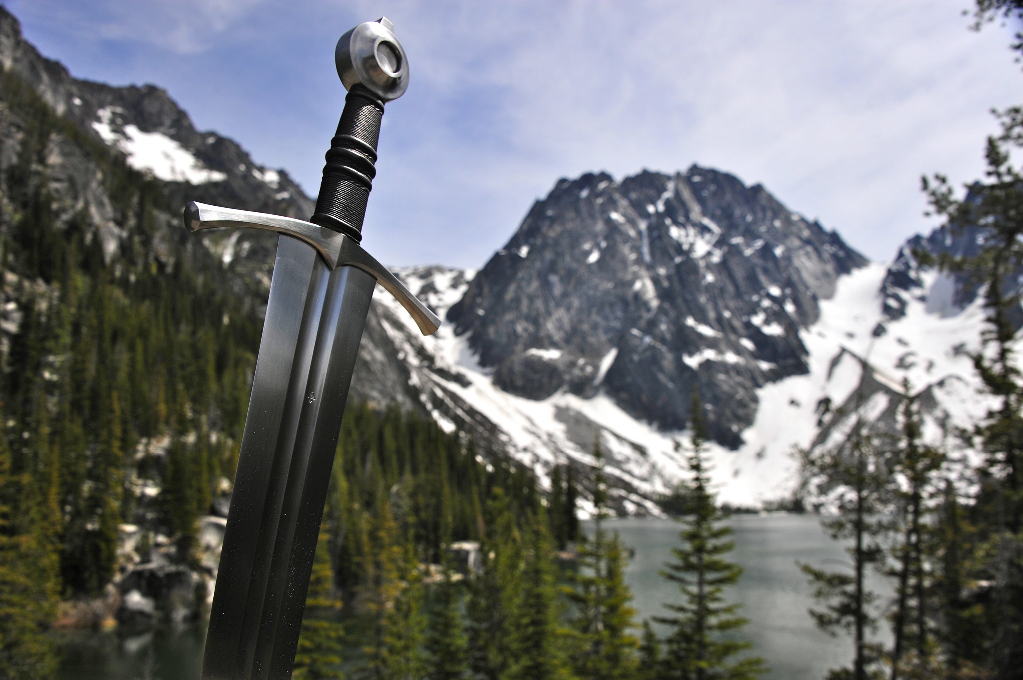 Sword in front of snowy mountains and lake HD Wallpaper