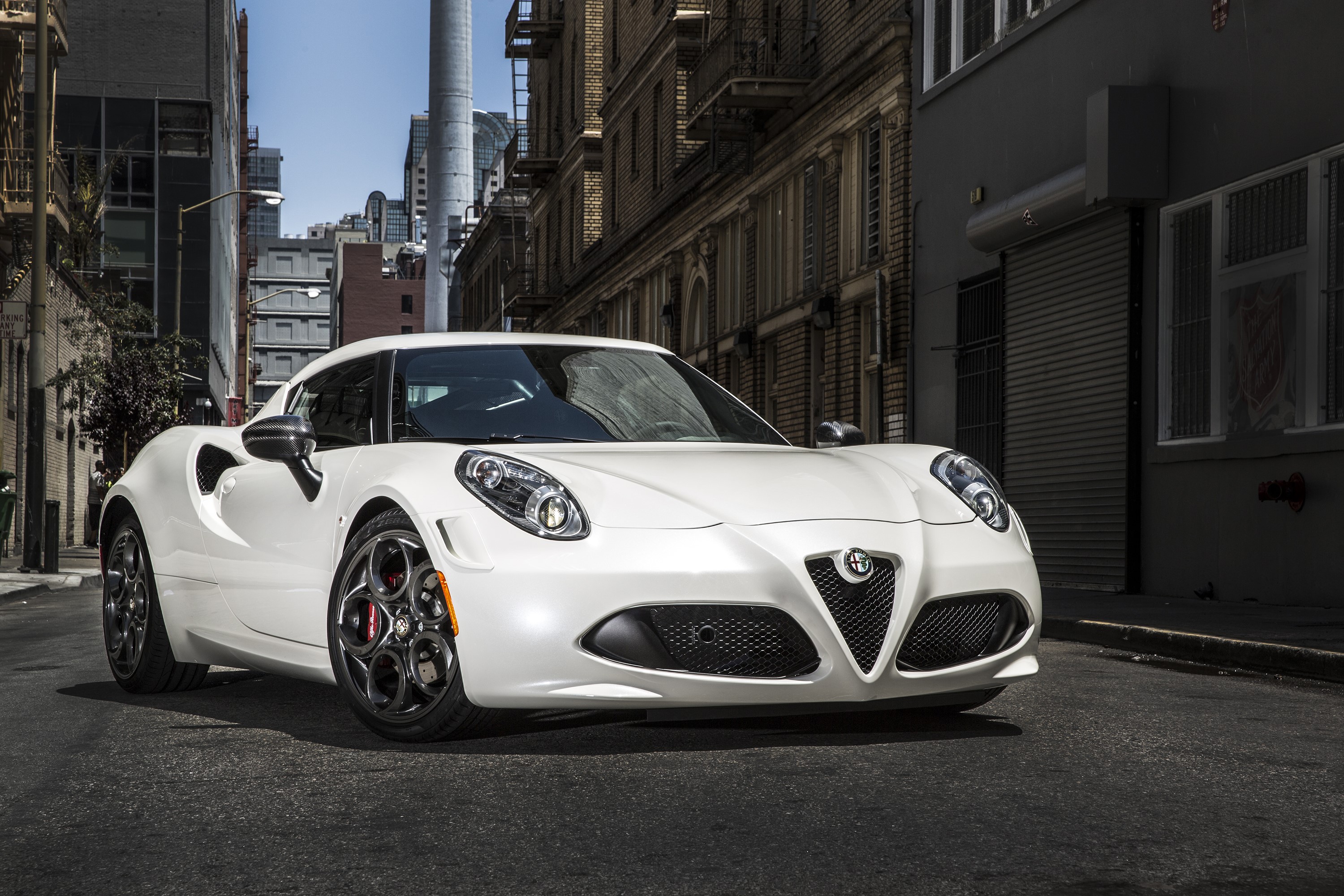 White 2015 Alfa Romeo 4C parked on a city street HD Wallpaper