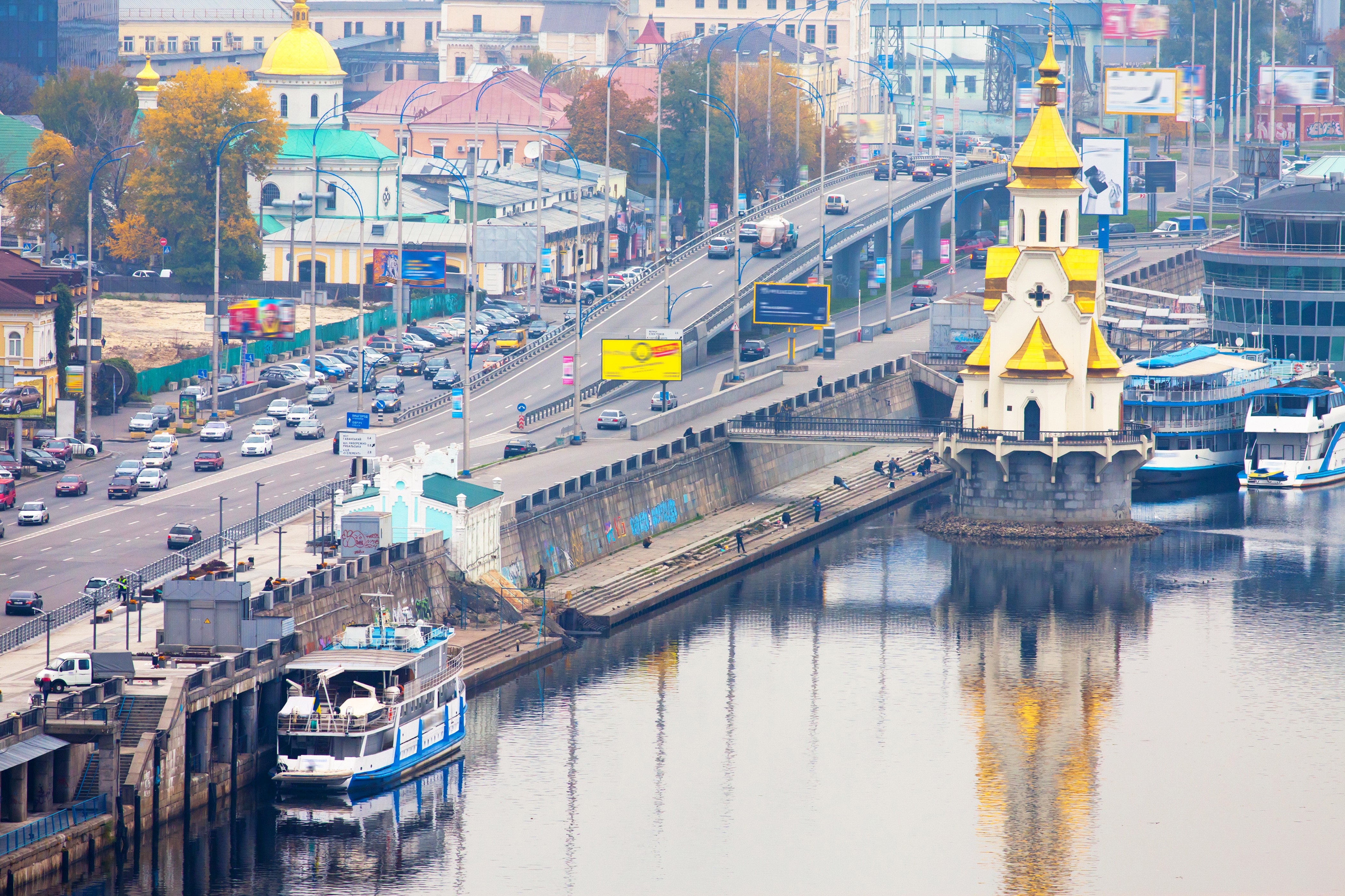 Cityscape with bridge, river, and church in Ukraine HD Wallpaper