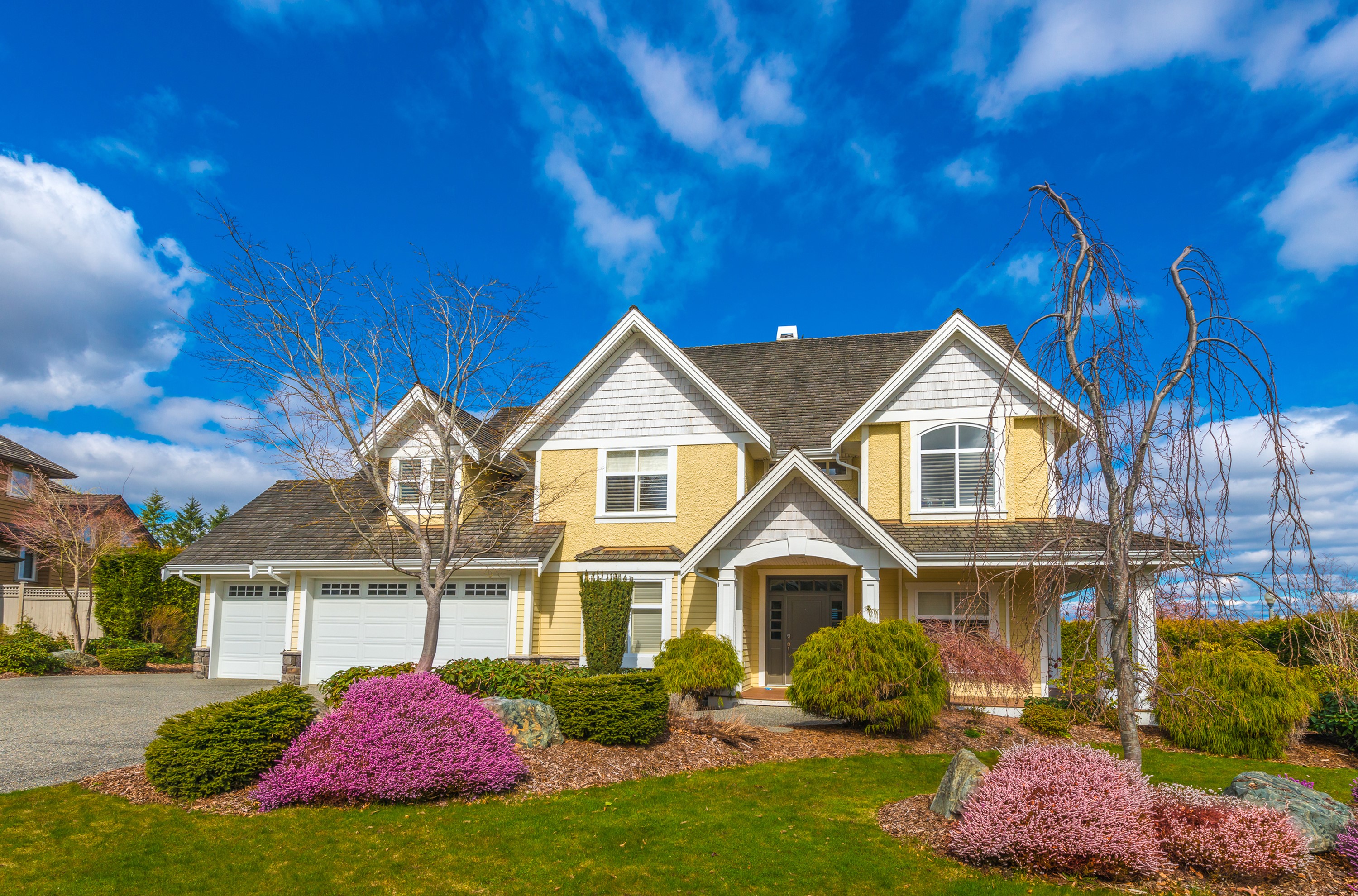 Yellow house with garage and landscaping HD Wallpaper