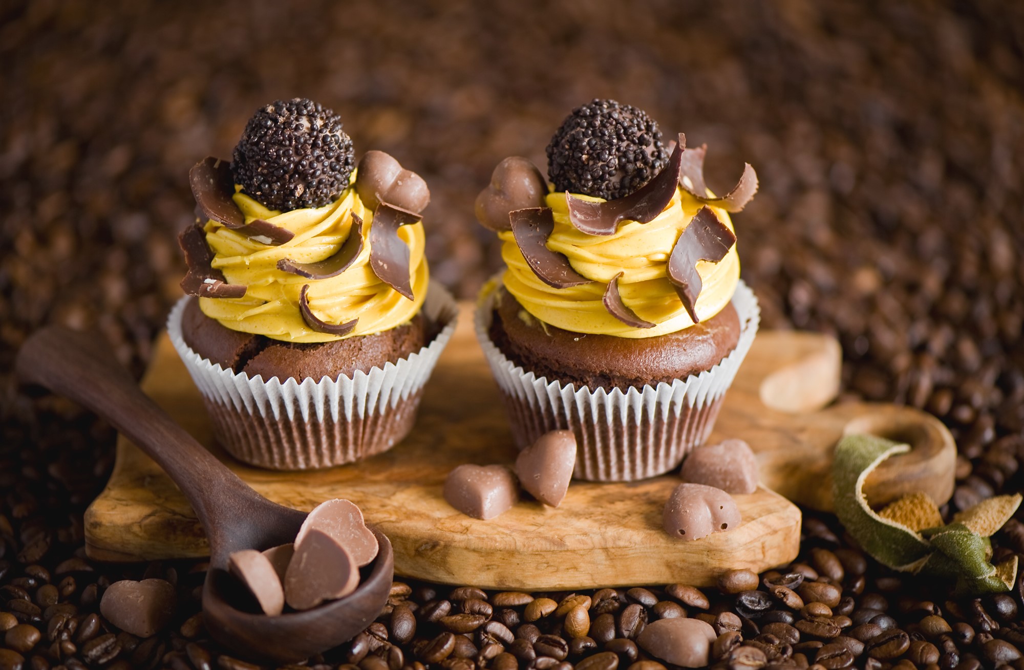 Chocolate cupcakes with yellow frosting and coffee beans HD Wallpaper