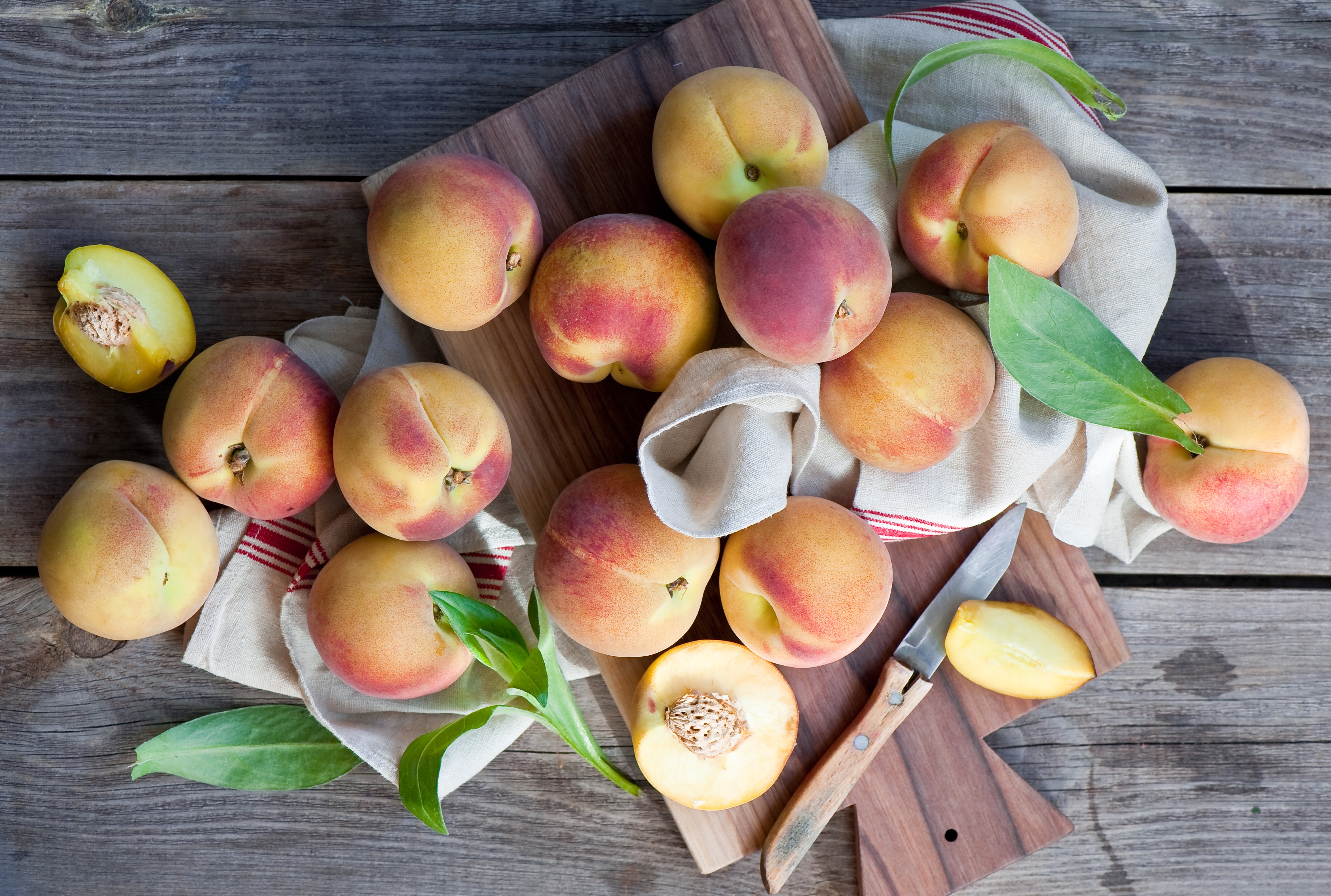 Peaches on a wooden table with a knife HD Wallpaper
