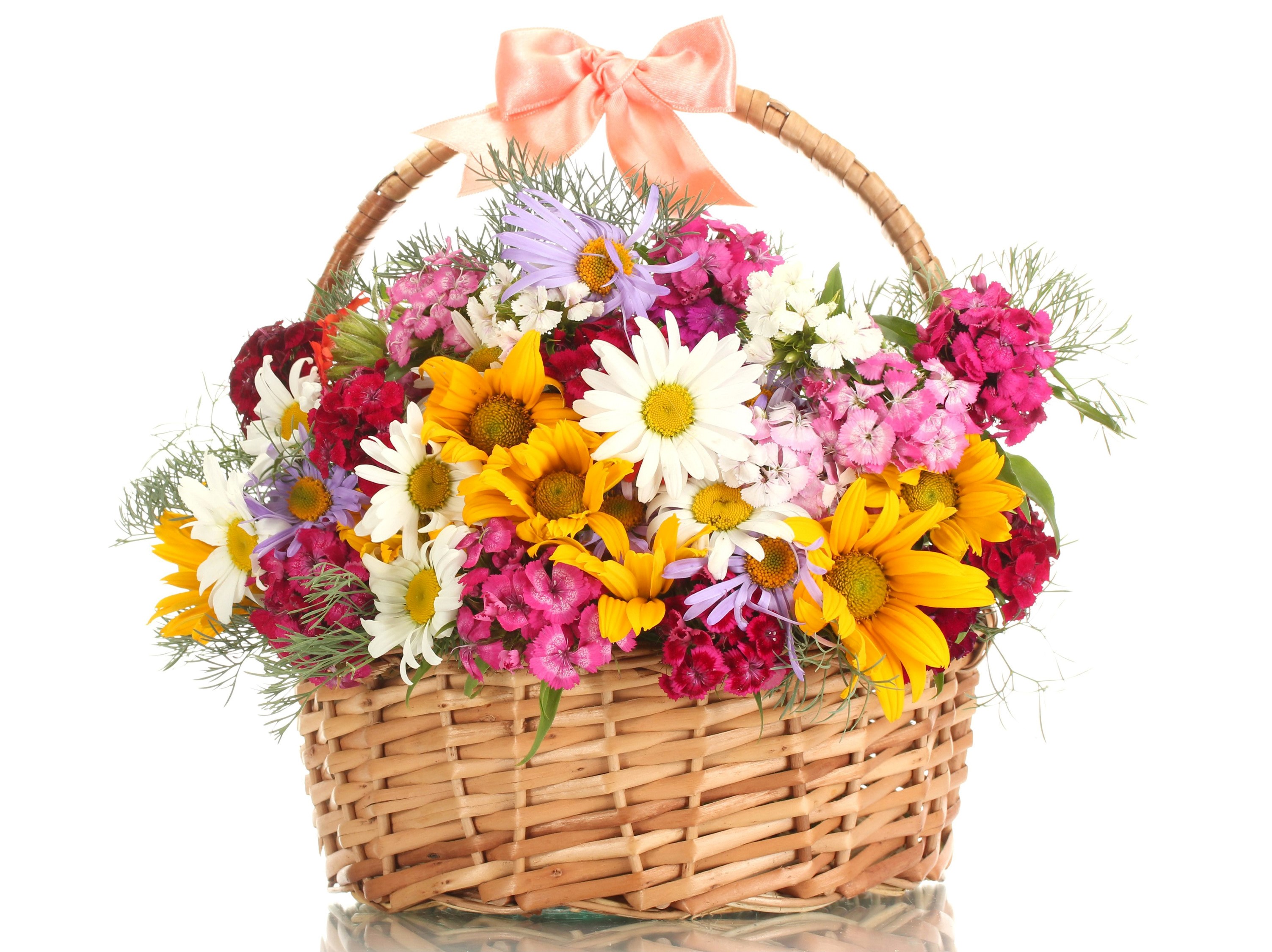Wicker basket filled with colorful wildflowers and a pink bow HD Wallpaper