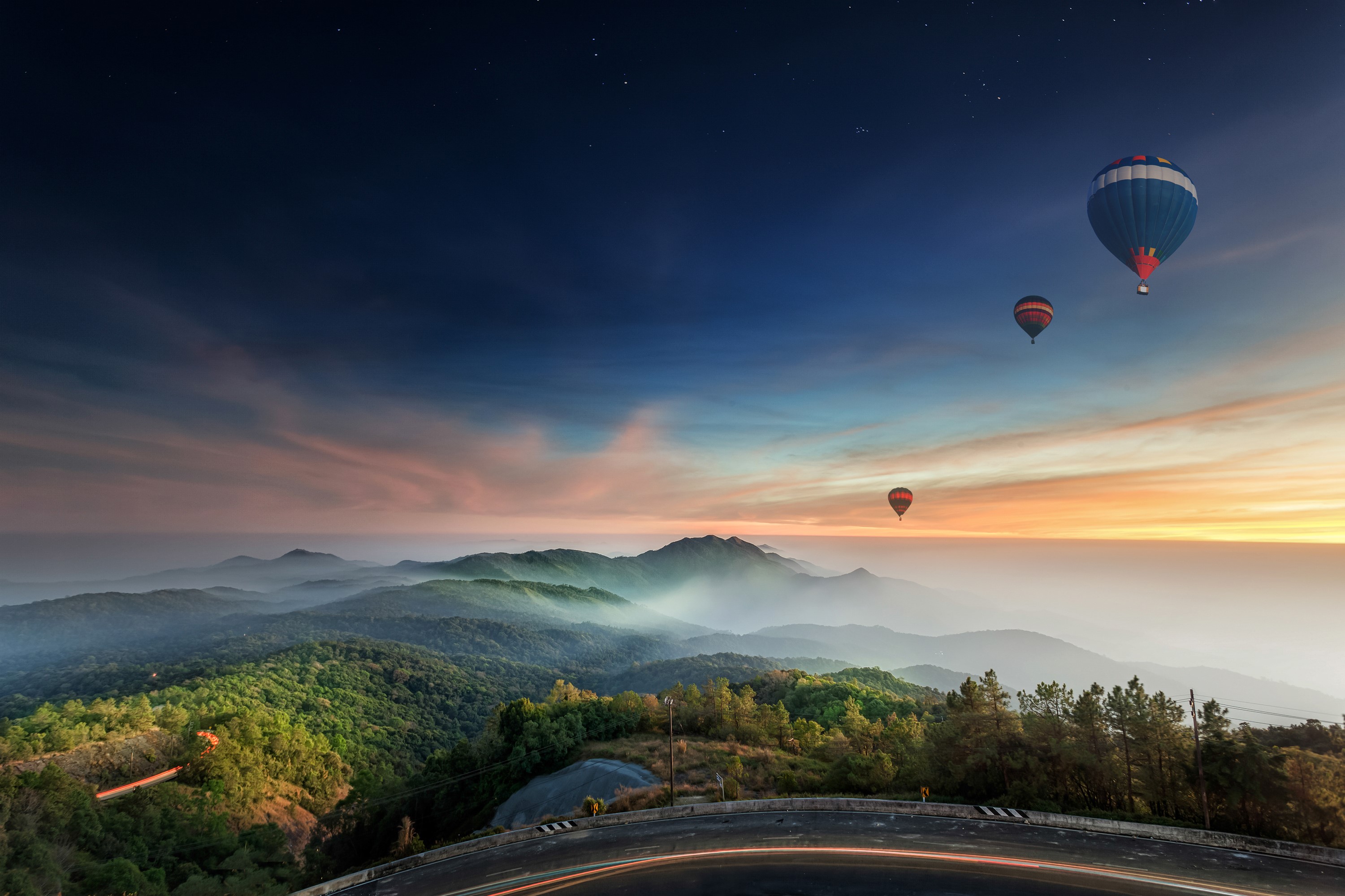 Hot air balloons over misty mountains at sunrise HD Wallpaper