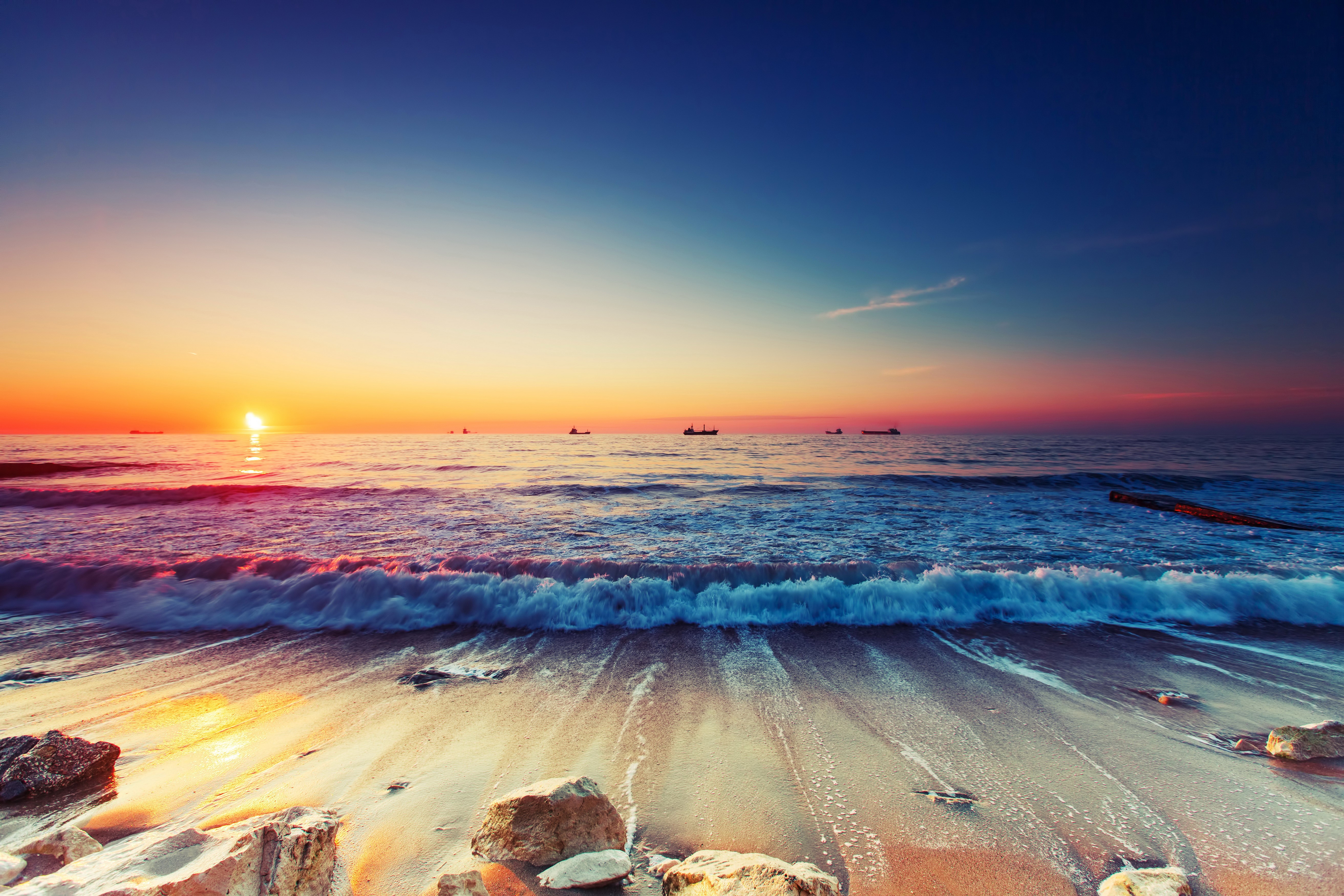 Sunset over the sea with ships on the horizon HD Wallpaper