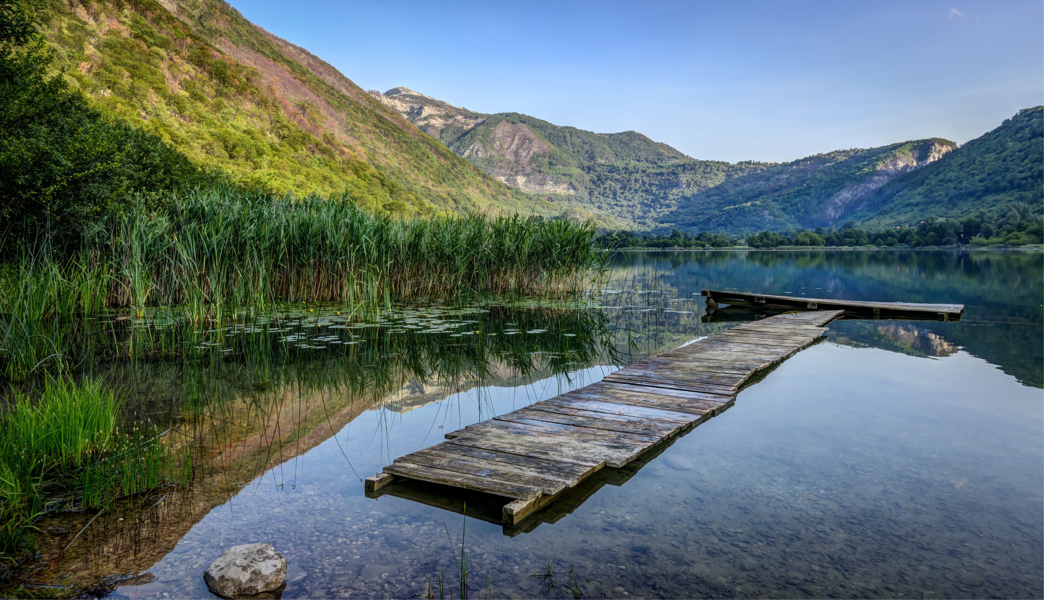 Boracko Lake in Bosnia and Herzegovina with mountains and a wooden pier HD Wallpaper