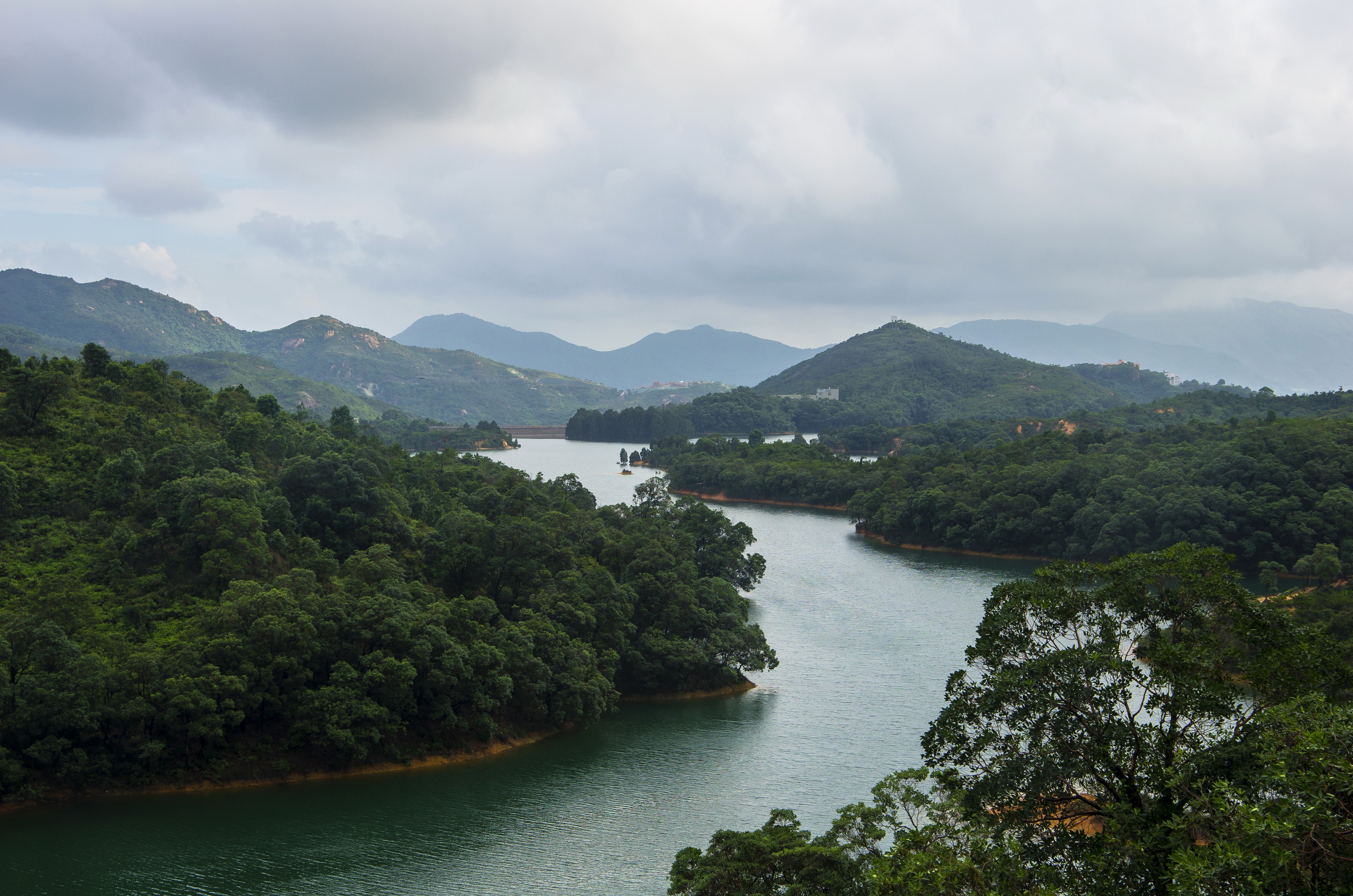 Reservoir surrounded by green hills in Hong Kong HD Wallpaper