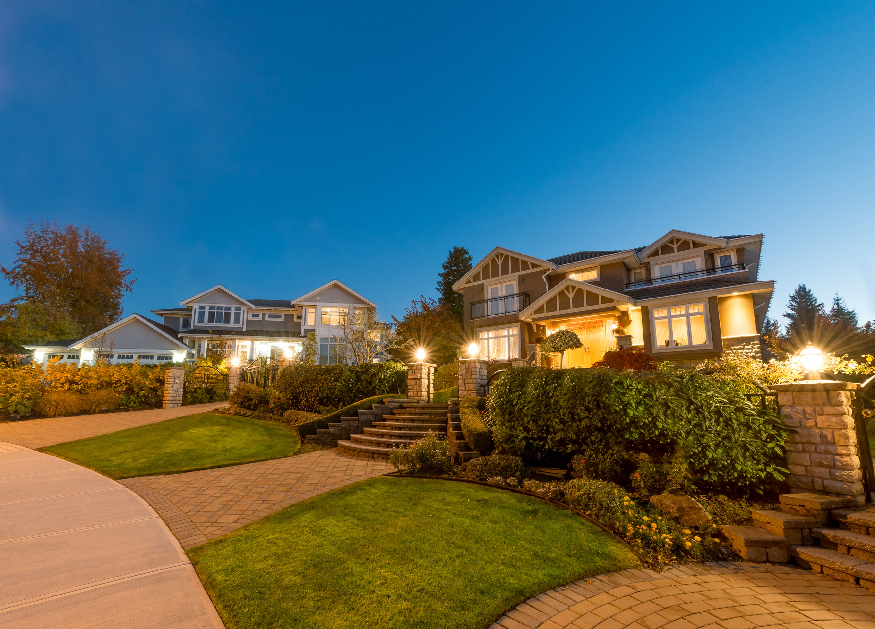 Luxury houses at night with illuminated landscaping HD Wallpaper