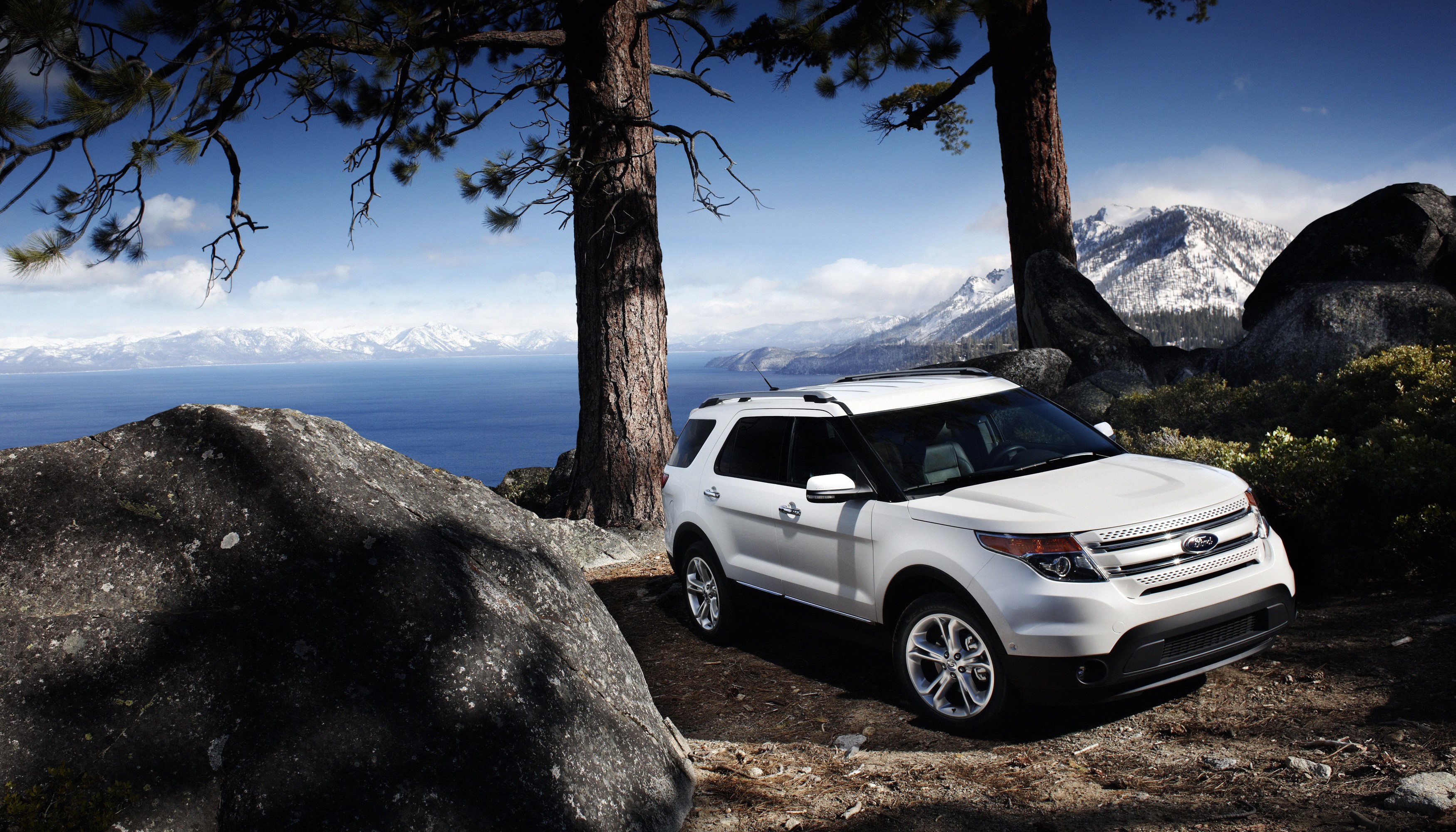 White Ford Explorer parked by a lake with mountains HD Wallpaper
