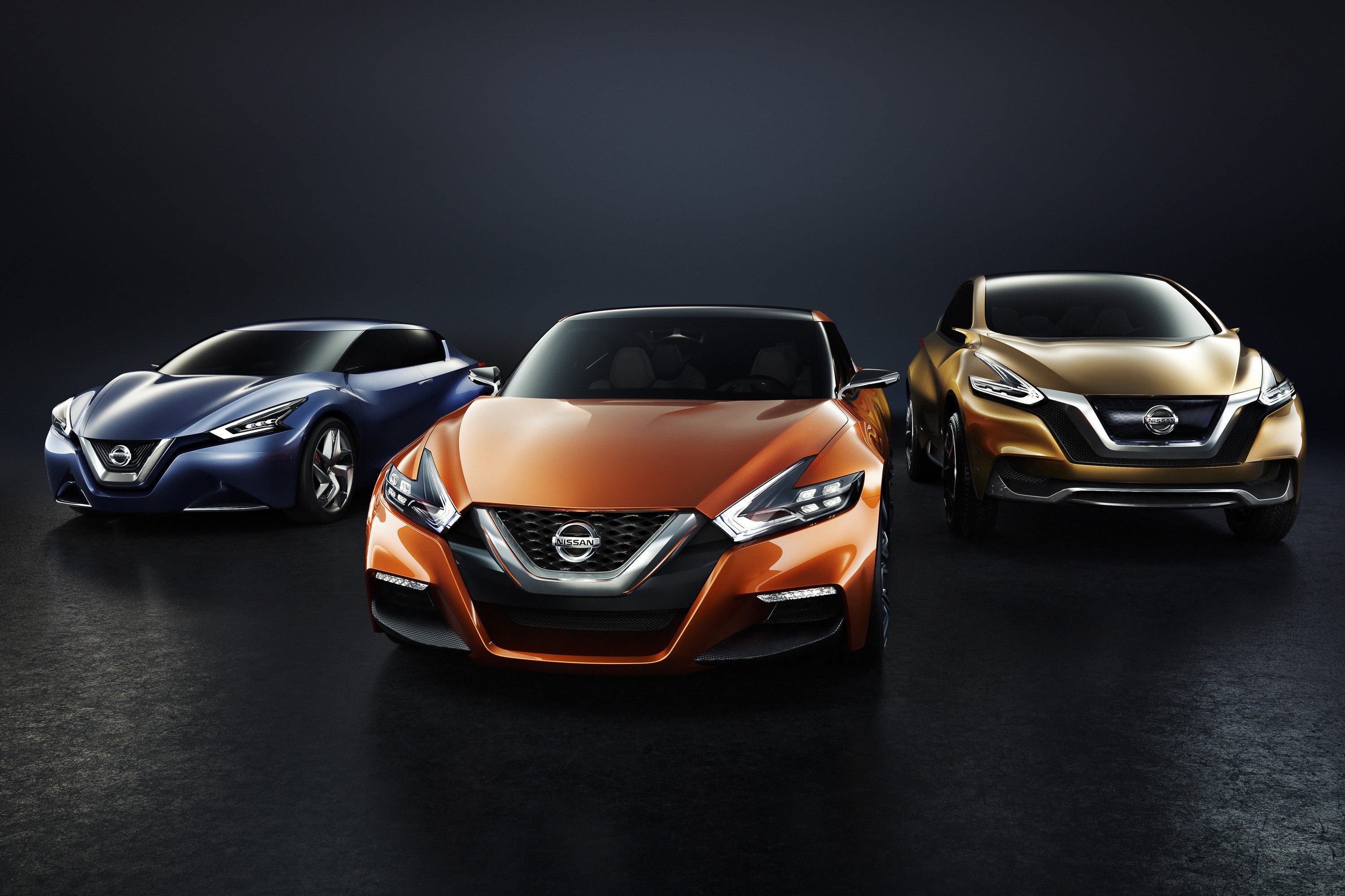 Three Nissan concept cars in orange, blue, and gold HD Wallpaper