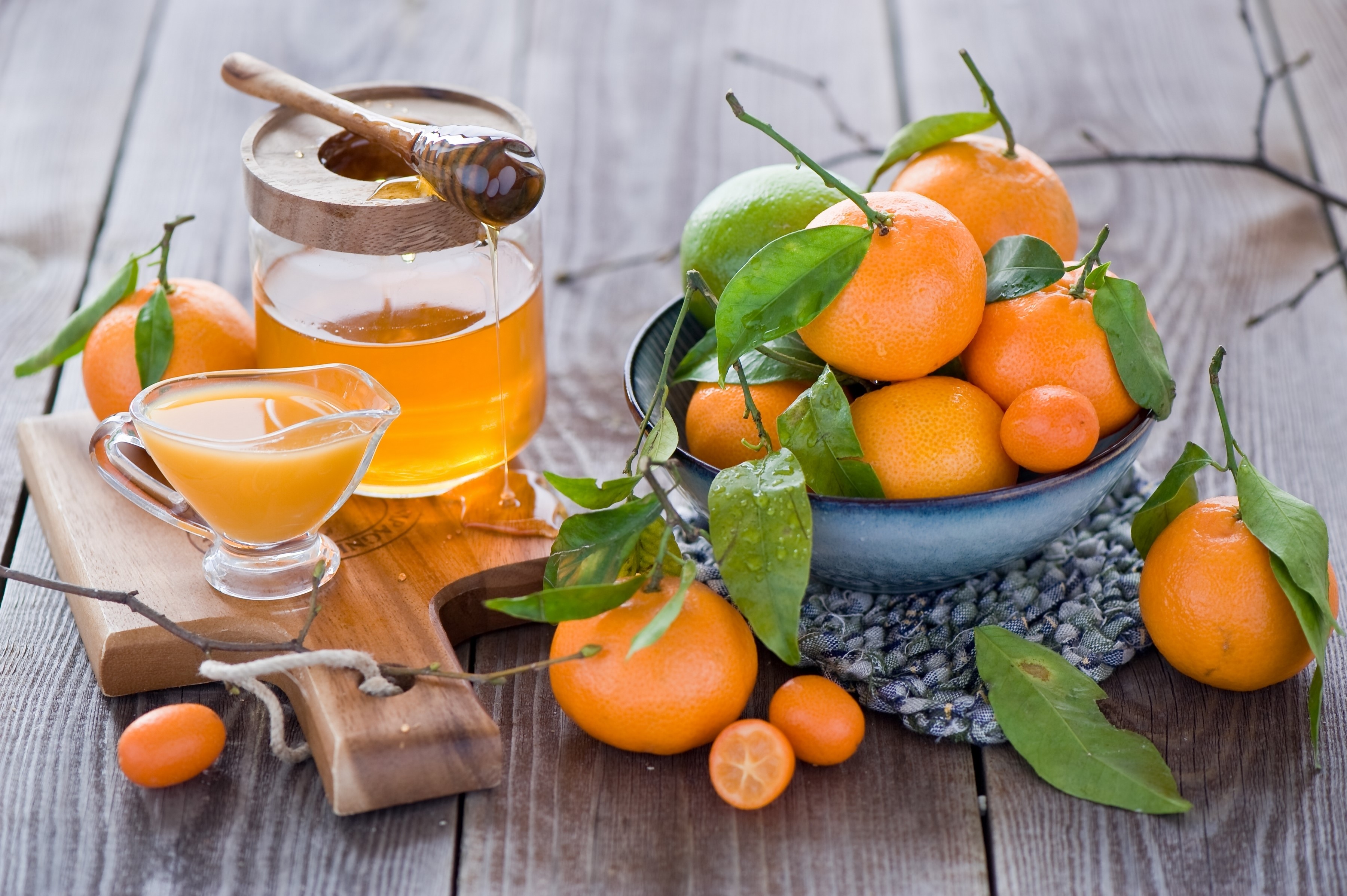Citrus fruits and honey on a wooden table HD Wallpaper
