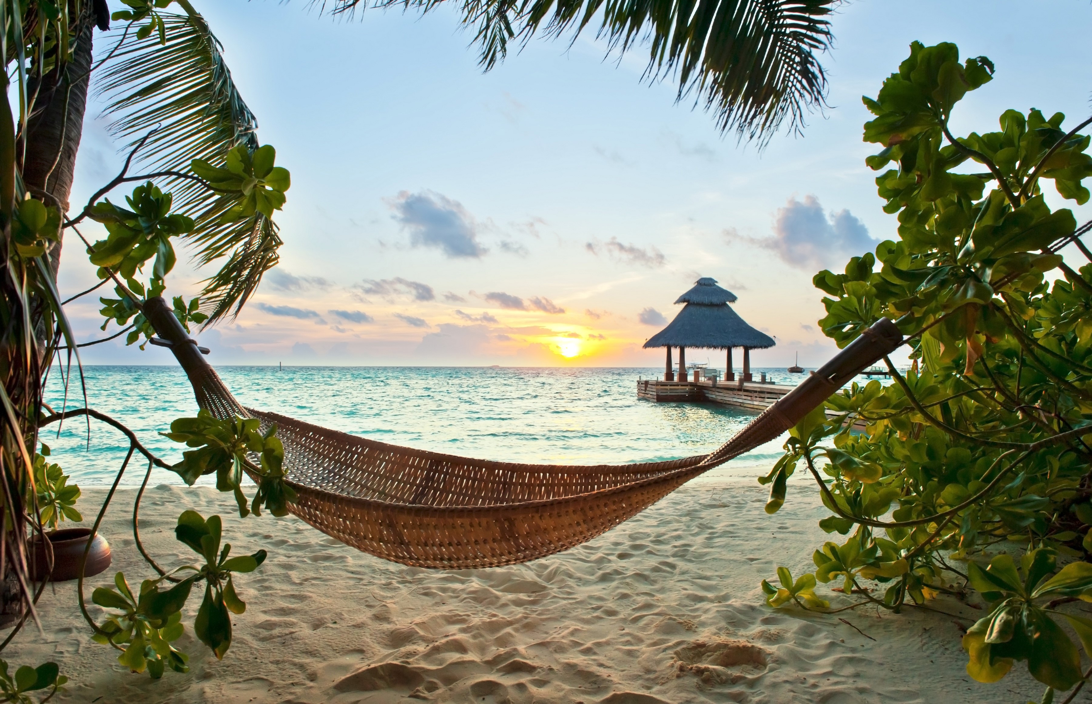 Hammock on a tropical beach at sunset HD Wallpaper