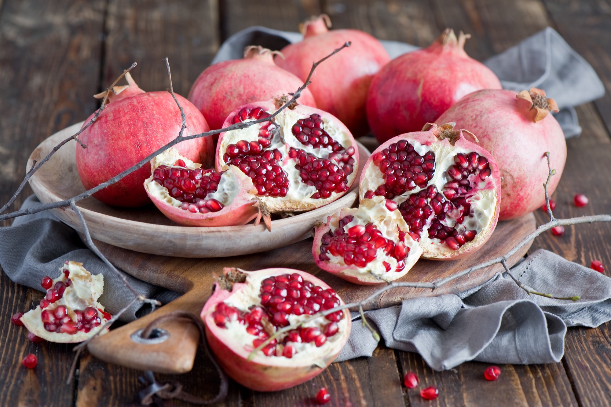 Pomegranates on a wooden table HD Wallpaper