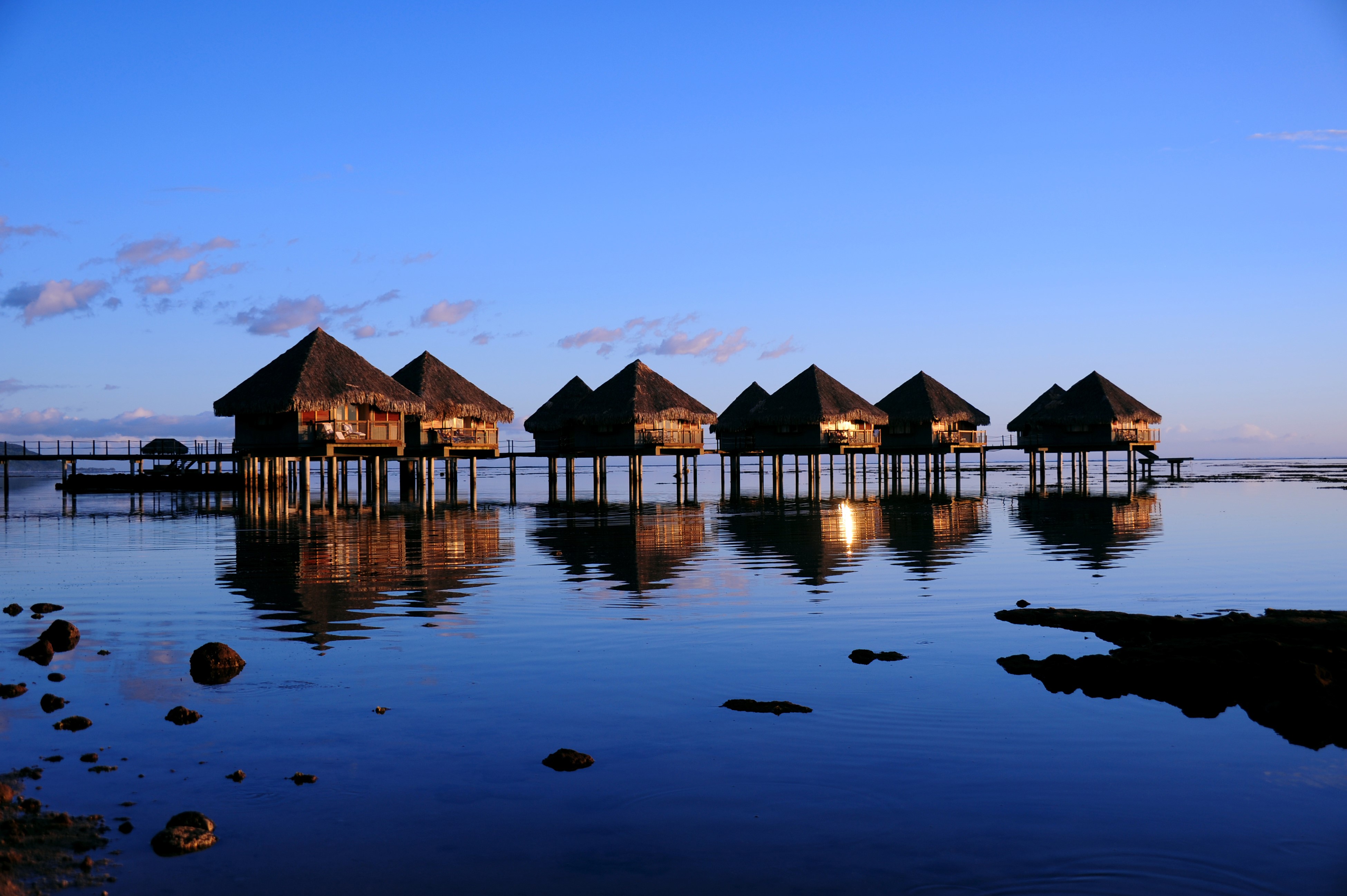 Overwater bungalows in Tahiti at sunset HD Wallpaper