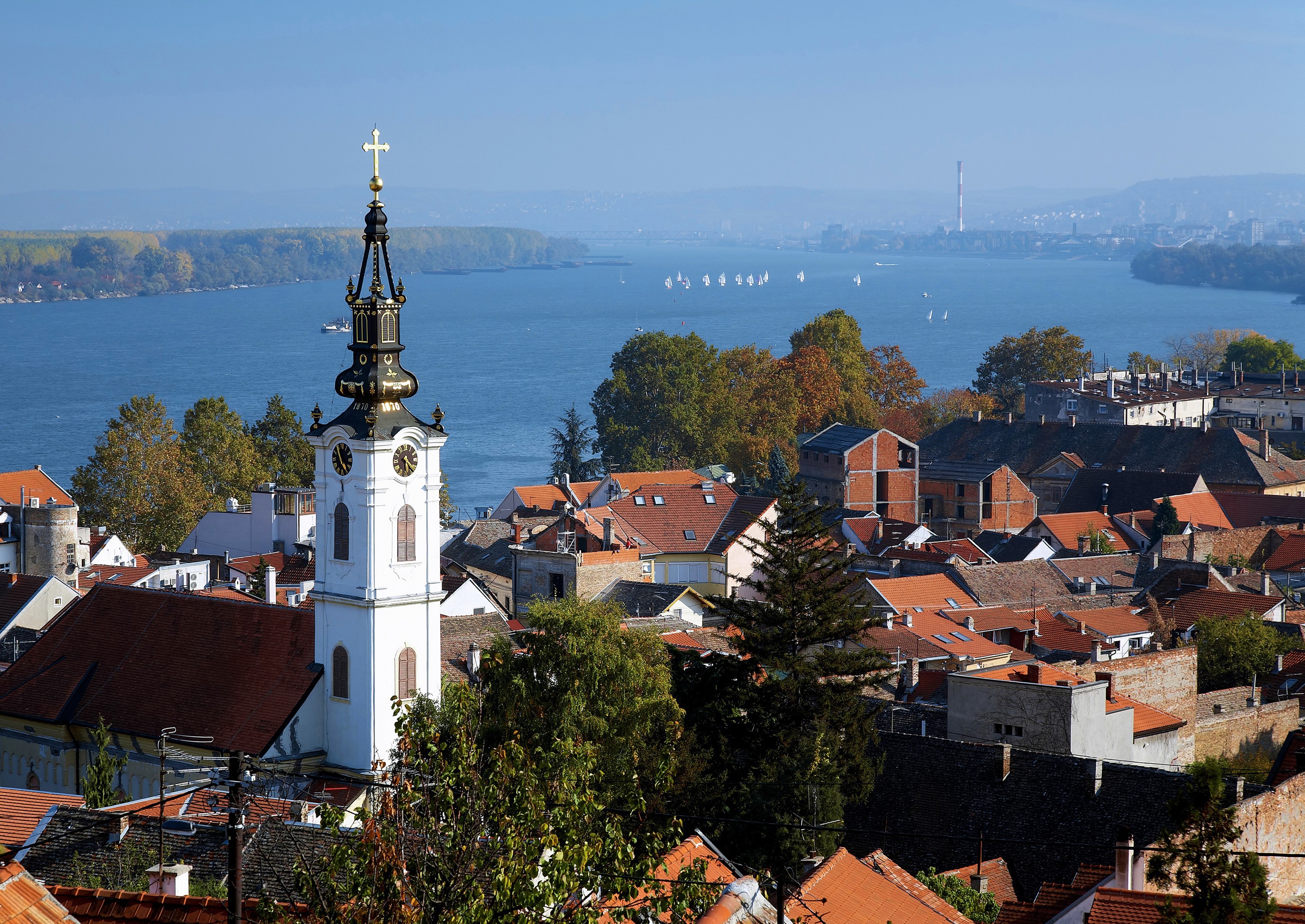 Church tower overlooking a river and city in Serbia HD Wallpaper