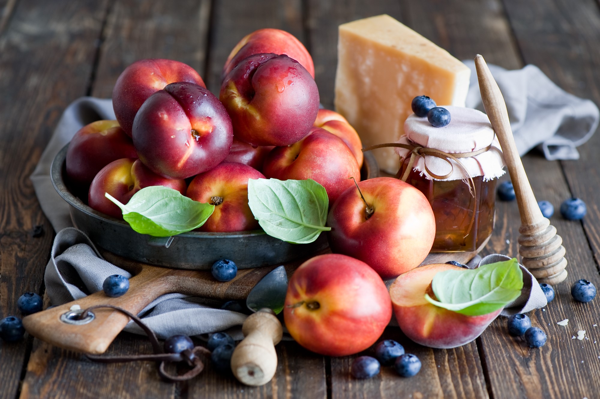 Peaches, blueberries, cheese, and honey on a wooden table HD Wallpaper