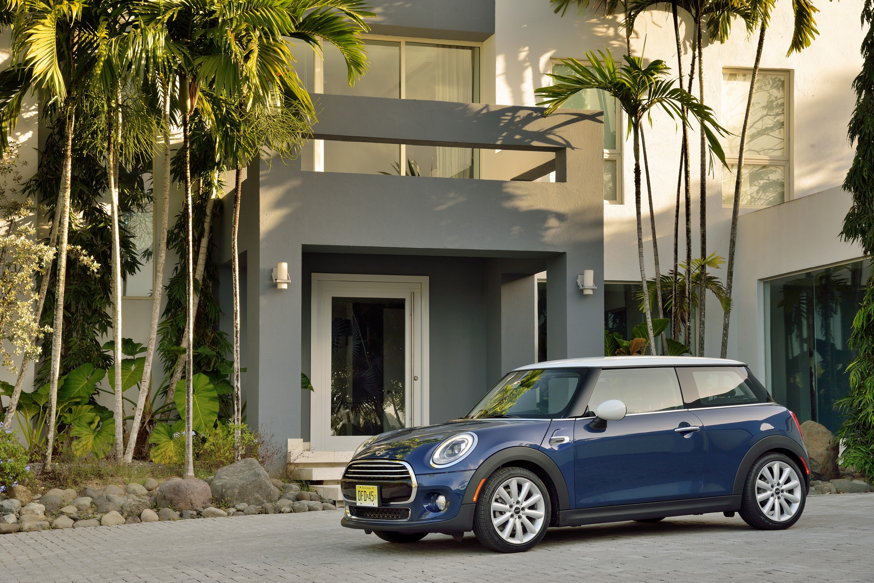Blue Mini Cooper F56 parked in front of a modern house HD Wallpaper
