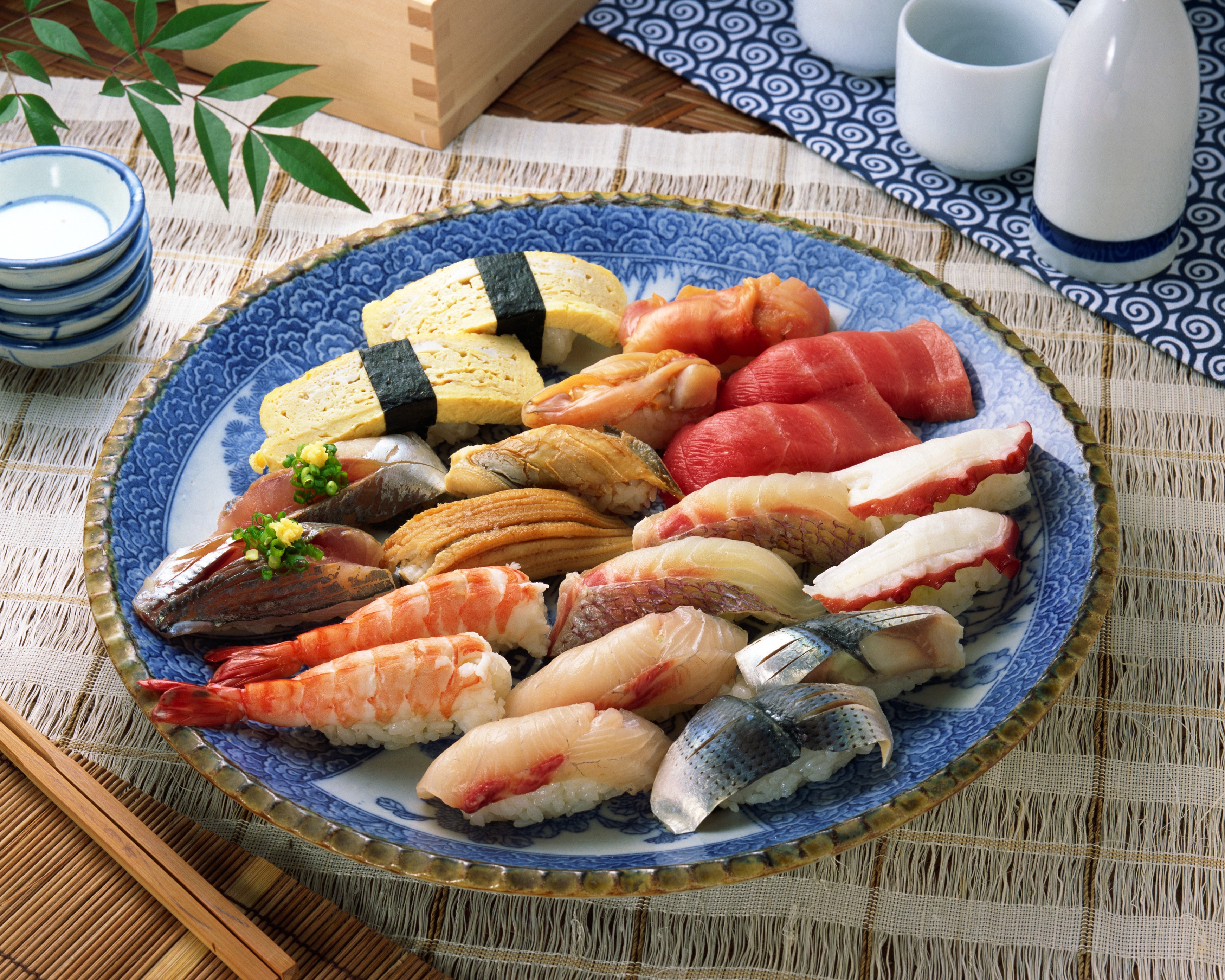 Assortment of sushi on a blue and white patterned plate HD Wallpaper