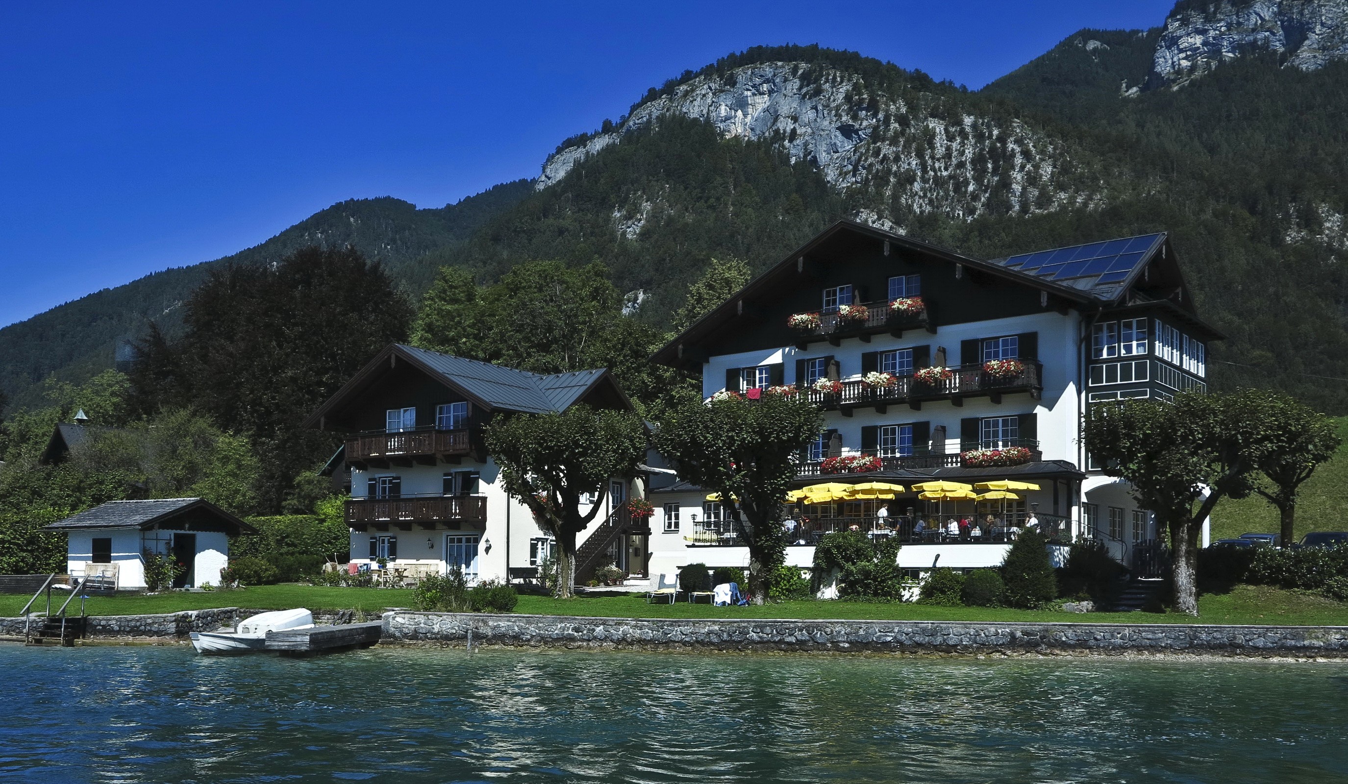 Houses on a lake in St Gilgen, Austria with mountains HD Wallpaper