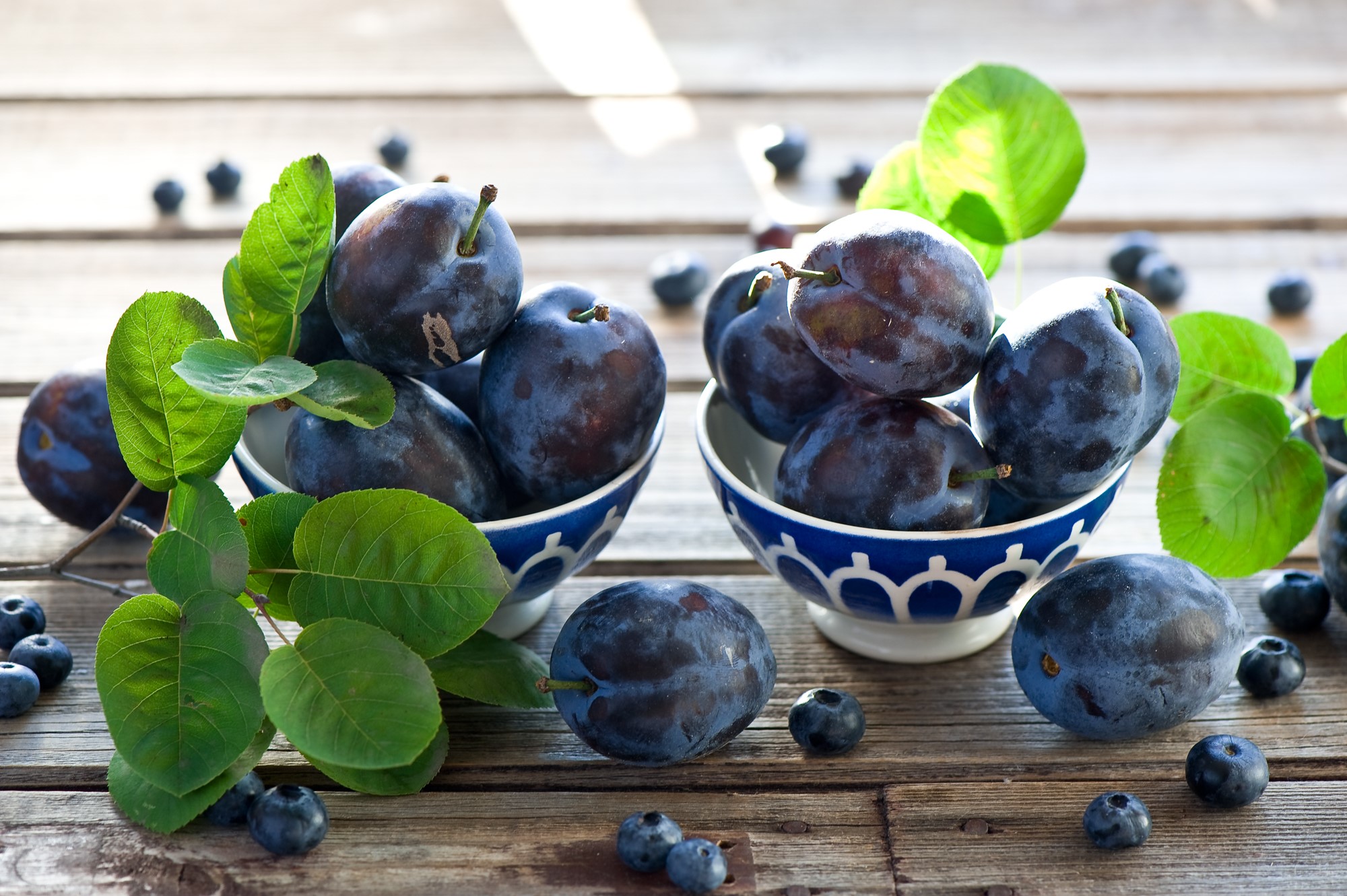 Plums and blueberries on wooden table HD Wallpaper