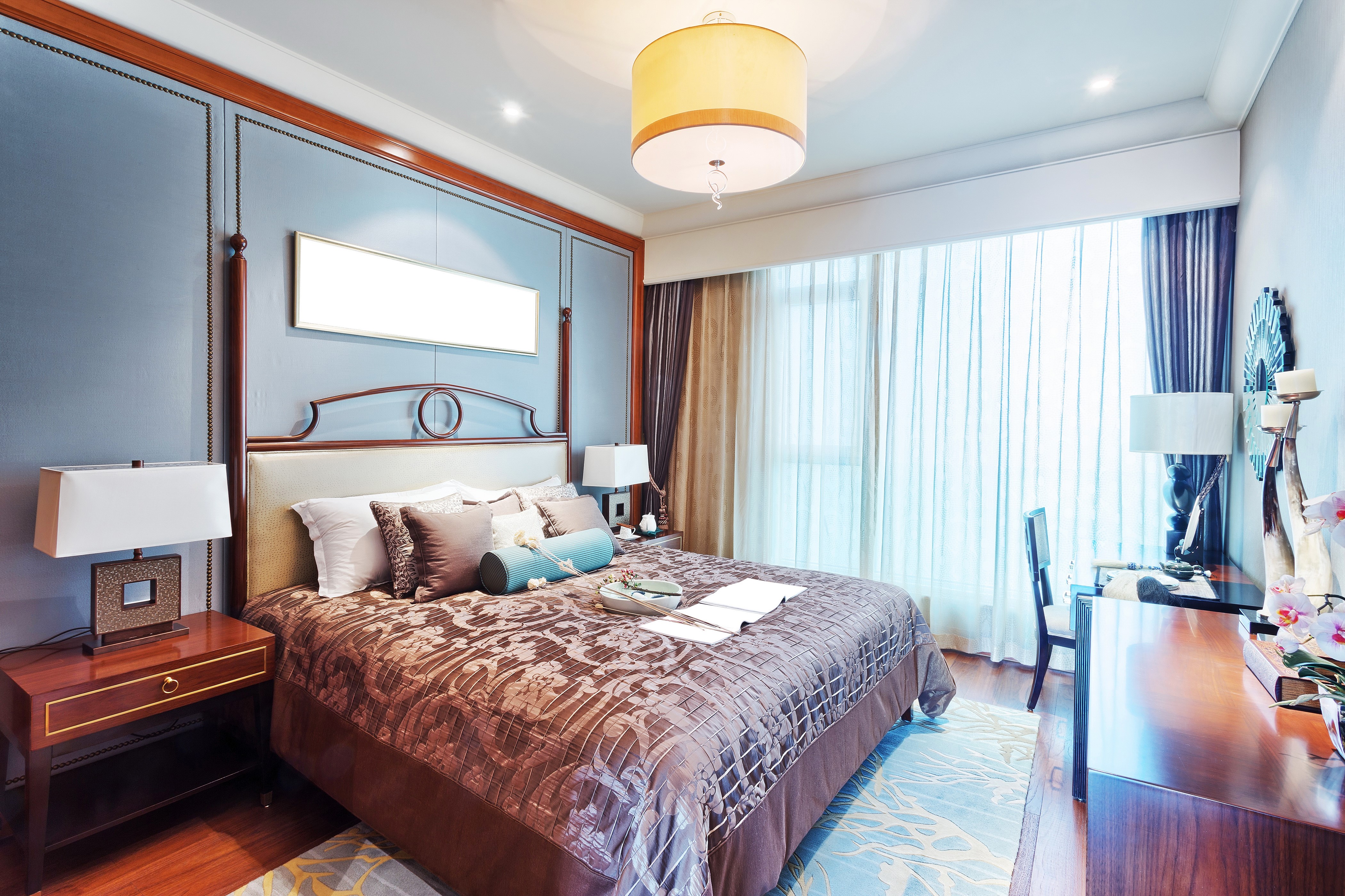 Bedroom interior with bed, lamps, and desk HD Wallpaper