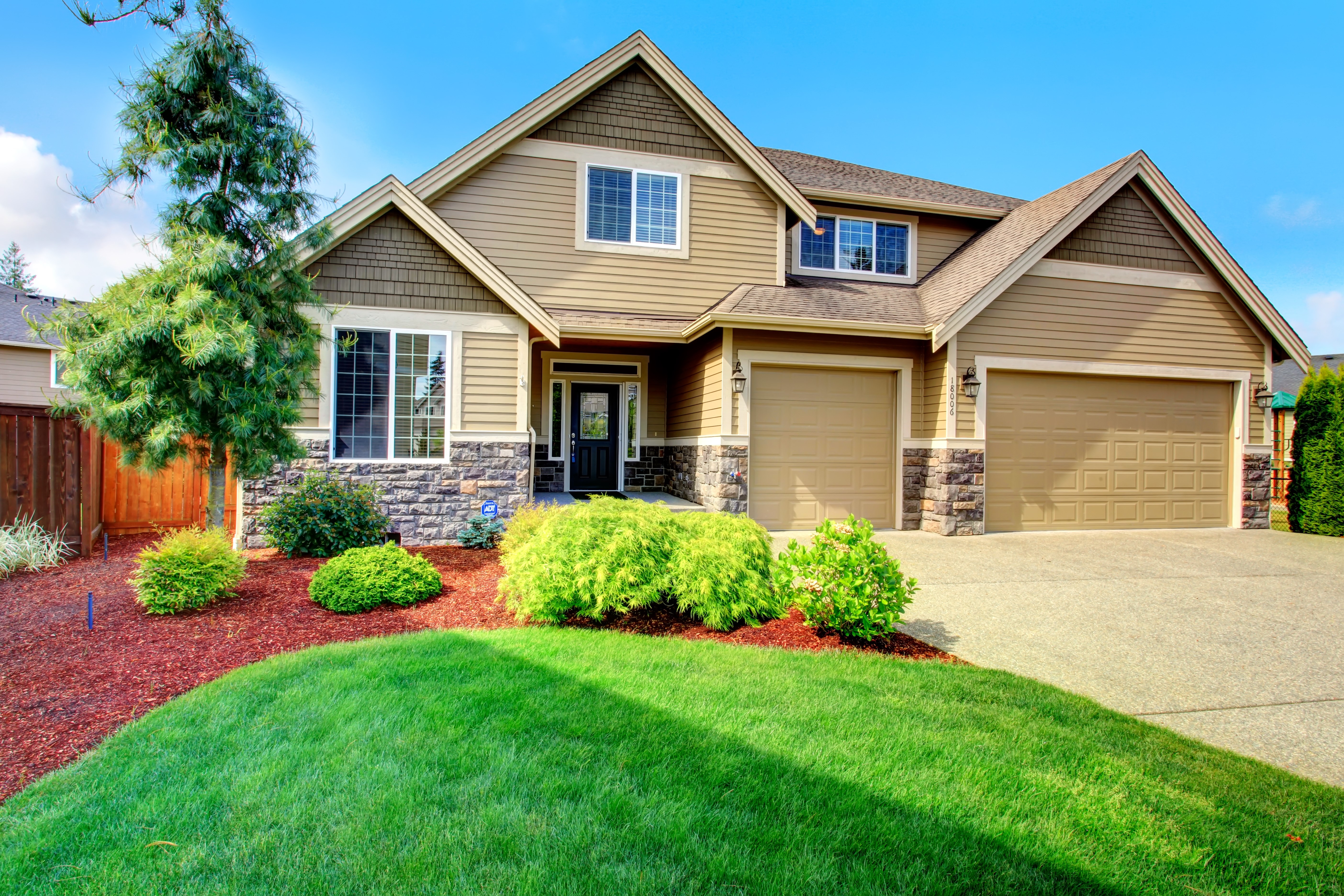 Tan House with Stone Accents and Double Garage HD Wallpaper