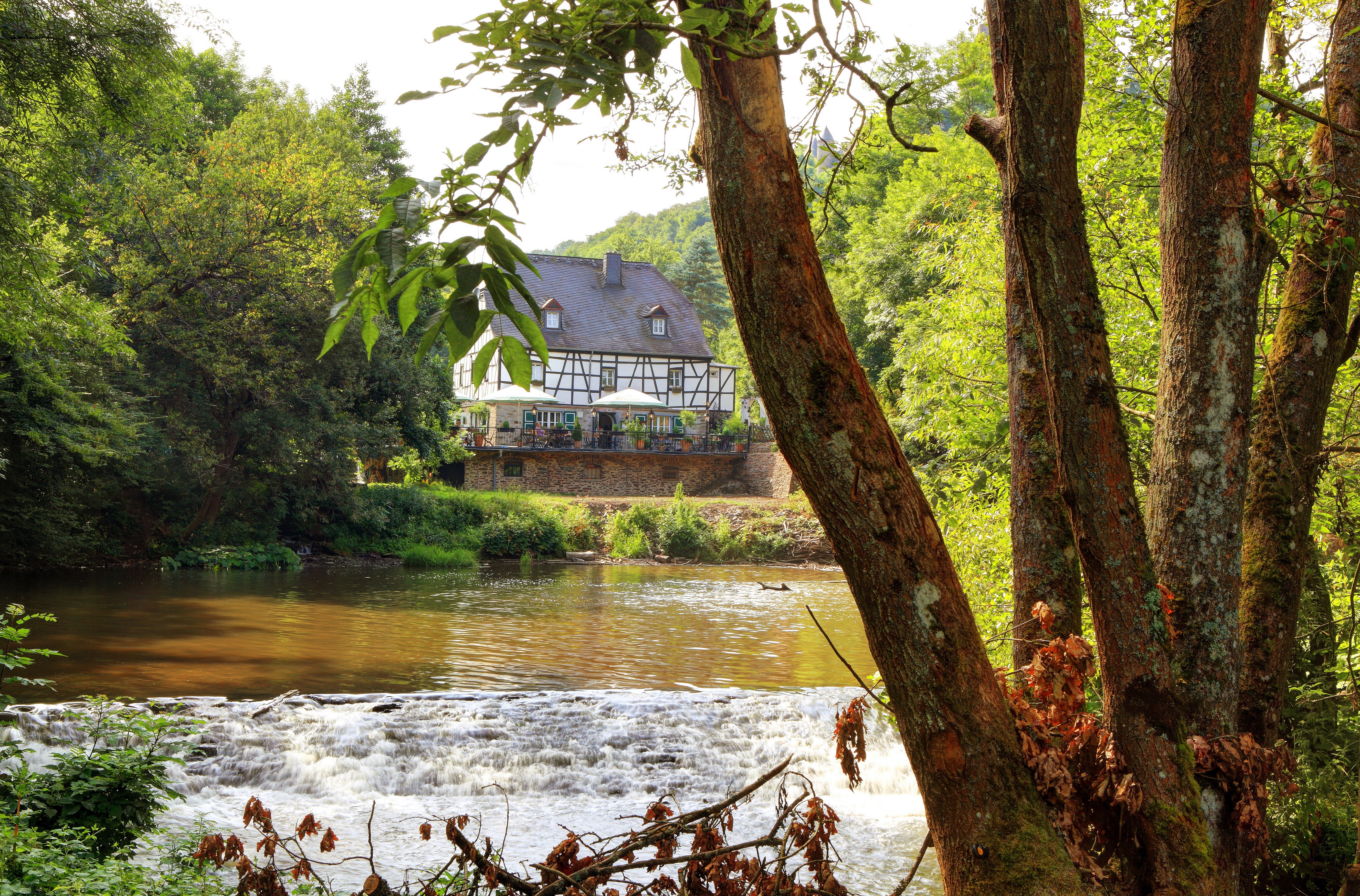 Half-timbered house by a river in Germany HD Wallpaper